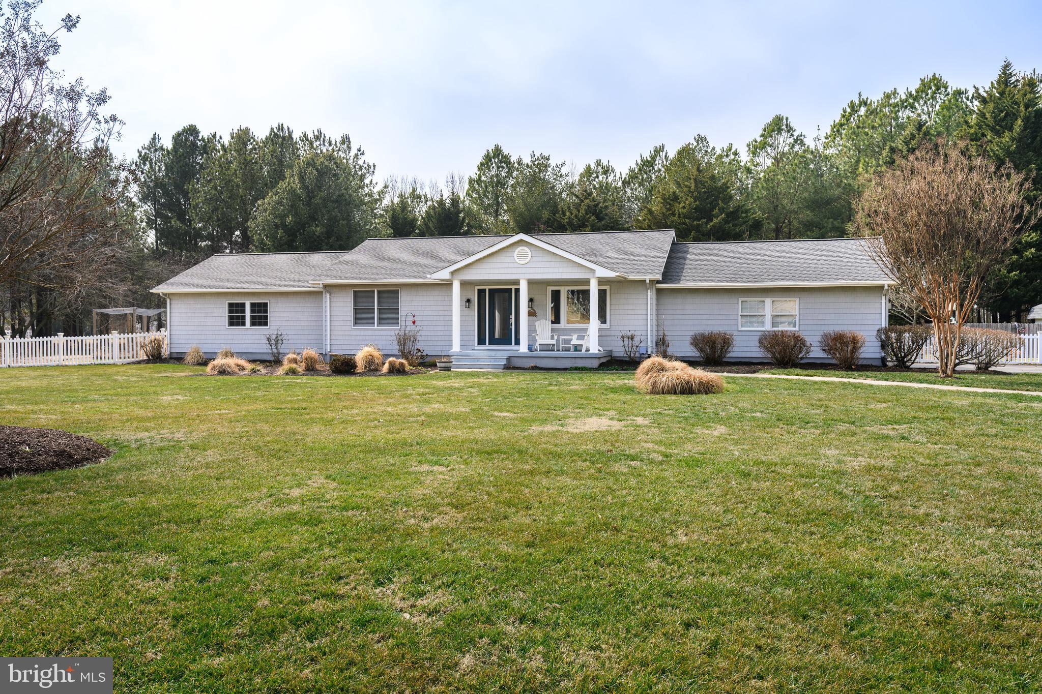 Set on more than 5 tranquil acres with woods, open space, and a partially fenced yard, this inviting one-level home offers a peaceful setting along the Wye River with glimpses of the water. Enjoy morning coffee or evening cocktails from the welcoming front porch while taking in the serene surroundings.

Inside, the thoughtfully designed floor plan features an open kitchen with granite countertops, a center island, and seamless flow into the spacious living room. A separate dining room sits just off the main living area, while the screened porch overlooks private farmland views and offers the perfect place to relax.

The oversized primary suite includes a vaulted ceiling, walk-in closet, and private bath. Two additional bedrooms feature hardwood flooring and share a full bath, with a convenient half bath and laundry area nearby.

This well-maintained home includes a brand-new roof, new heating and air units with warranty, a new nitrogen septic system designed for long-term use, and high-end vinyl siding for low-maintenance living. The bathrooms have been updated, and a screen porch was added when the roof was replaced. Additional highlights include minimal steps for easy accessibility, an attached two-car garage, a detached one-car garage, and comfortable spaces throughout.

Full of possibilities and move-in ready, this is a home you can truly enjoy for years to come.