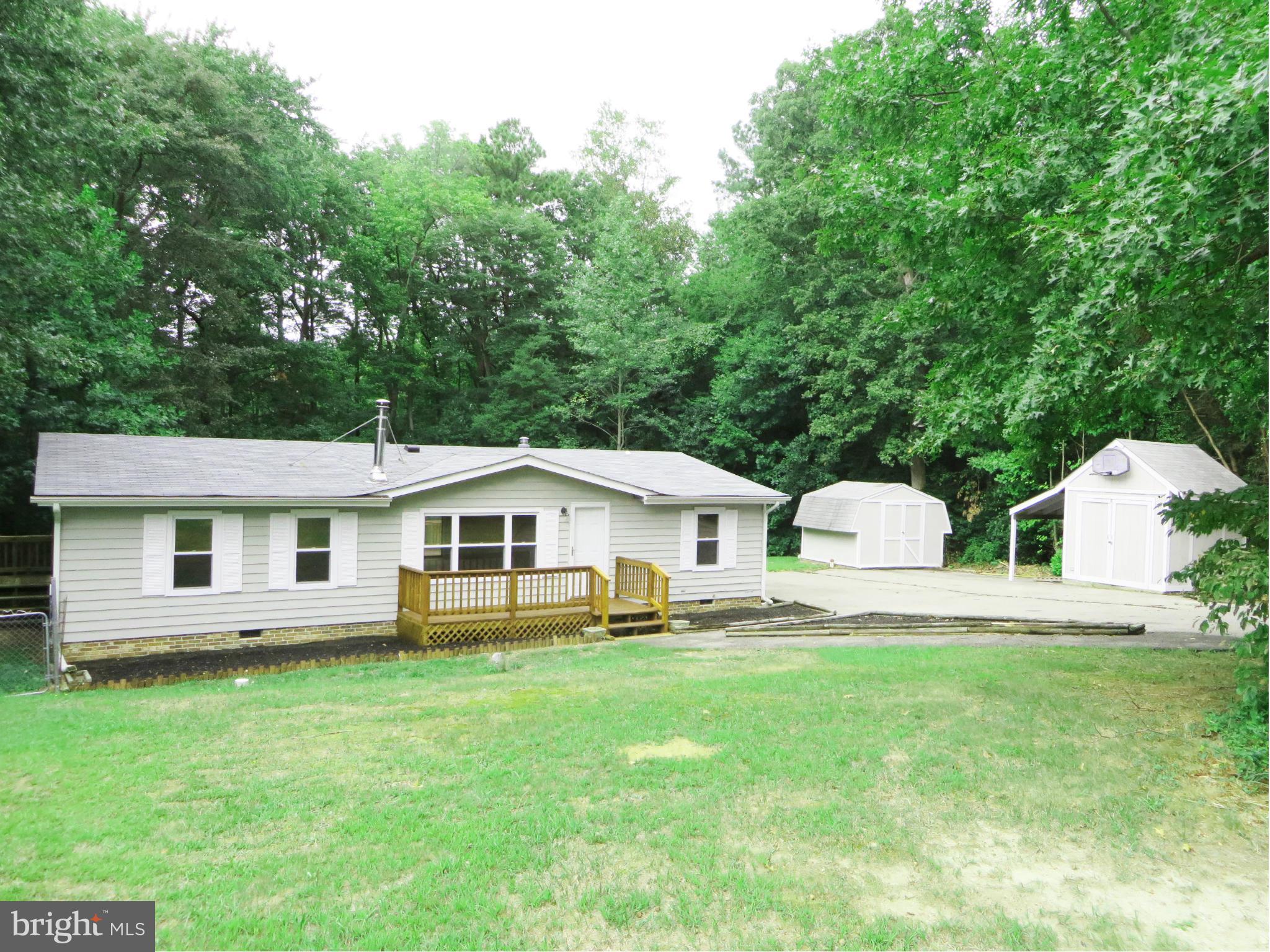 Great starter home on an acre, nice privacy & no HOA! You'll love the improvements: laminate floors; recent roof, gutters, & A/C; thermal tilt-in windows; light fixtures; vapor barrier & ductwork in crawl! Plenty of KT cabinets & counter space, w/pantry & gas stove. Warm woodstove w/new piping in LR, cozy in winter! Dining rm w/slider to deck. Sep laundry rm, W/D stay. Two sheds, huge paved drive!