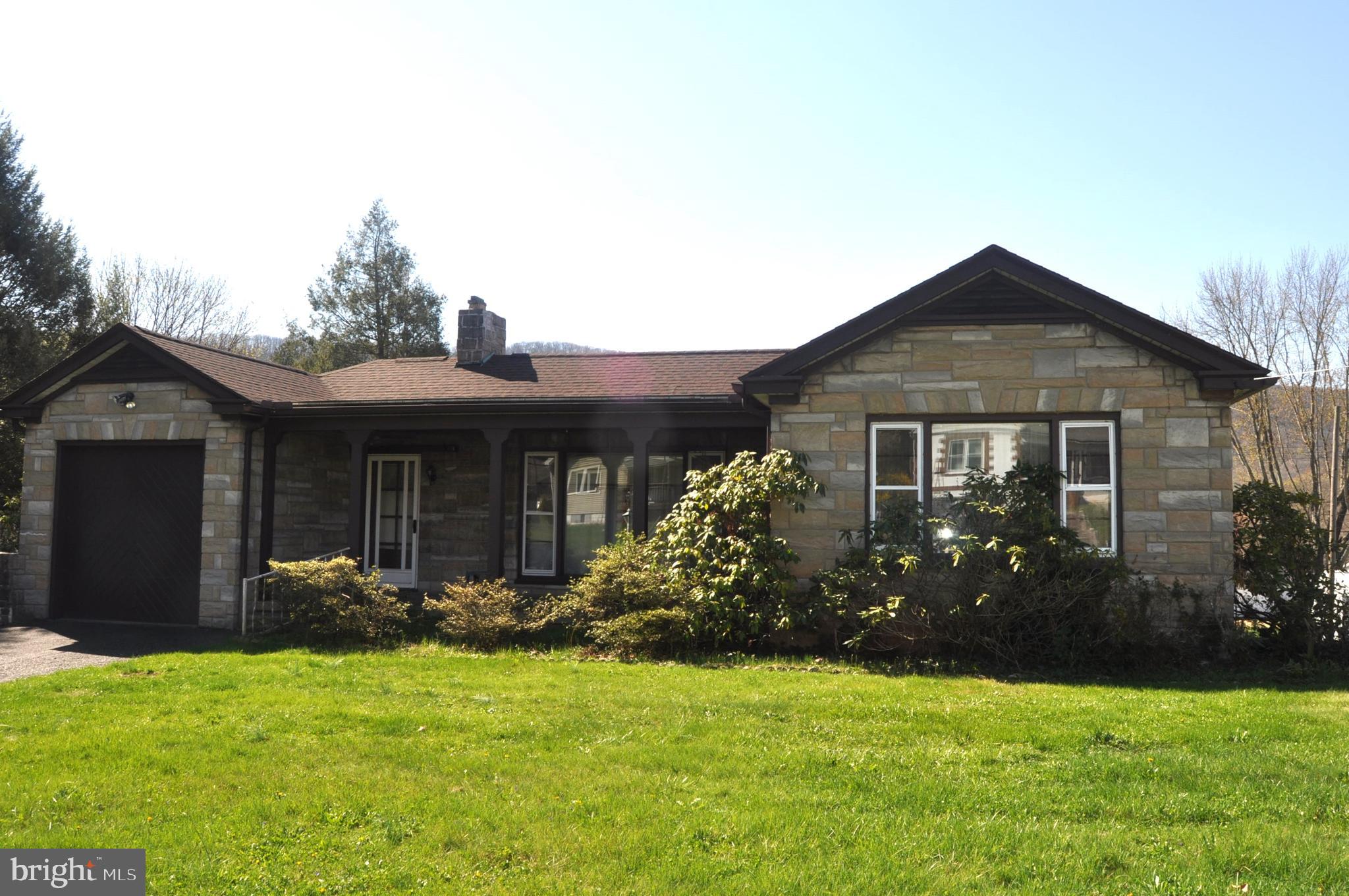 Two bedroom ranch home on 0.45 acre  lot with 1,560  square feet of living space. Spacious living room with gas fireplace, kitchen, dining room and sunroom. Original hardwood floors, recent roof and oil boiler renewed in 2018. Full attic with pull down stair access. Mini-splits for cooling and heat, ceiling fans and whole house fan. Full basement with high ceilings, interior access and two exterior entrances plus toilet facilities. Relax on the front porch or small covered patio. One car attached garage & detached storage shed. Public rear alley access.