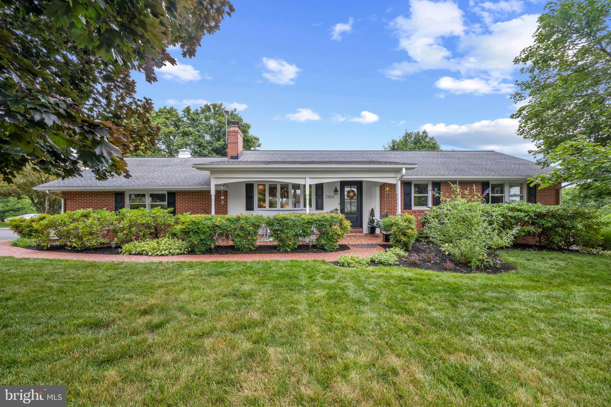 Renovated brick ranch-style residence offering 3 bedrooms, 3 full bathrooms, and 2,373 finished square feet, perfectly nestled on a beautifully landscaped lot in sought-after Sykesville. A stone-lined driveway leading to a side-load 2-car garage and a charming brick walkway bordered by luscious landscaping welcome you to the spacious covered front porch. // Step inside the inviting foyer, where hardwood flooring extends throughout most of the open-concept main level. The sun-filled living room serves as the heart of the home, featuring a cozy wood-burning fireplace flanked by custom built-ins and a graceful bow window that fills the space with natural light. // The adjoining dining room is enhanced by elegant wall detailing and an additional bow window, creating a bright and welcoming atmosphere. Seamlessly connected to the kitchen by a peninsula breakfast bar, this layout is ideal for both everyday living and entertaining. // The beautifully updated eat-in kitchen showcases quartz countertops, white cabinetry, stainless steel appliances, and a classic white subway tile backsplash accented with a decorative inset. Just beyond, a spacious laundry and mudroom offers abundant storage and convenient exterior access. // Hardwood flooring continues throughout the three main-level bedrooms, including the serene owner's suite featuring a beautifully renovated private ensuite bathroom. A second full bathroom thoughtfully serves the additional bedrooms. // The fully finished walk-out lower level expands the home's living space with a spacious recreation room highlighted by plush carpeting, a wood-burning fireplace, and a wet bar area—perfect for entertaining family and friends. This level also includes a full bathroom, a versatile bonus room ideal for a home office, hobby room, or guest space, and a storage room. // Enjoy outdoor living from the expansive deck complete with a retractable awning, providing the perfect setting for dining, relaxing, or entertaining. The beautifully landscaped, fully fenced backyard offers plenty of green space to enjoy, along with a convenient storage shed for gardening tools and outdoor equipment.