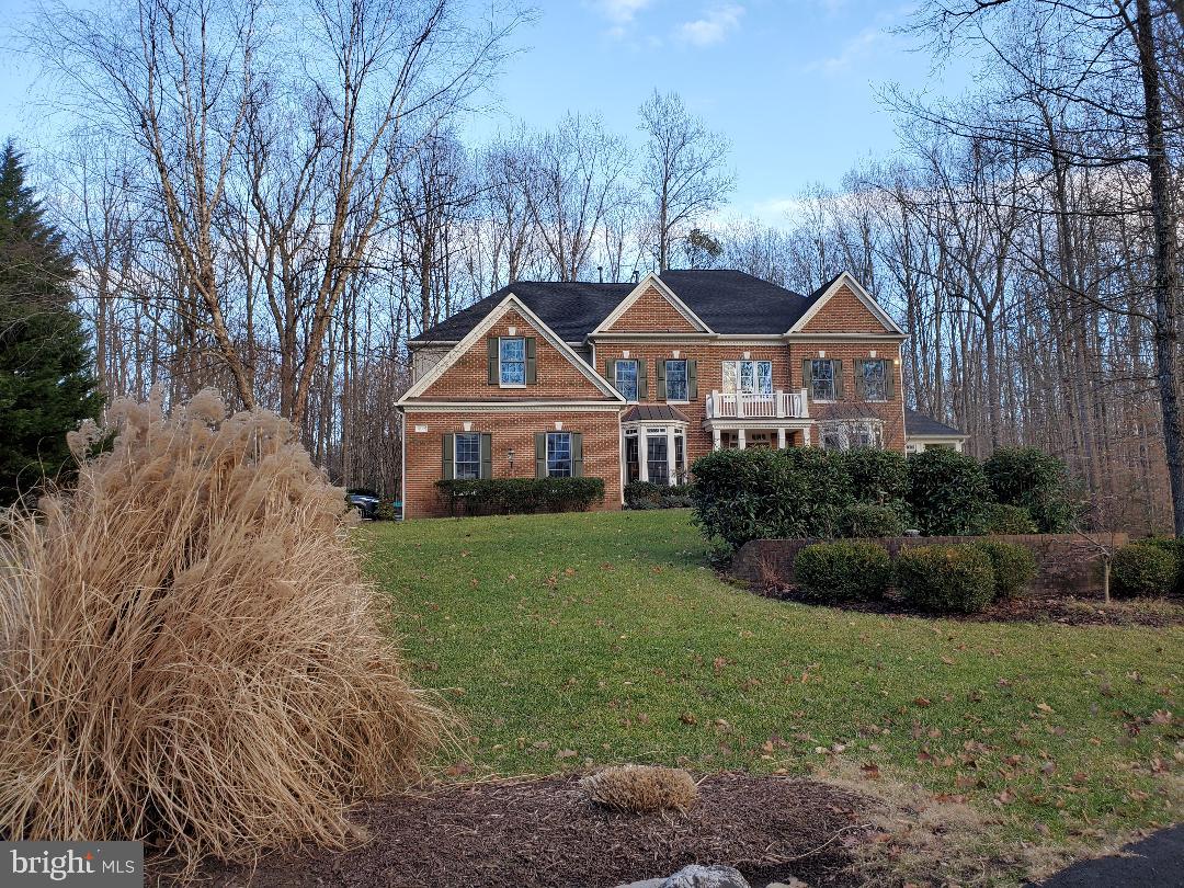 THIS IS IT – a 7,800 square foot luxury residence sitting on 5.5 wooded acres is waiting for you in the Estates at Roseland in southern Fairfax County. This gracious, welcoming, lovingly maintained home offers flowing, modern family living on a quiet cul-de-sac, free from urban noise and offering private outdoor enjoyment.  The main level of this beautiful 5 bedroom/4+ bath features:  hardwood flooring and  crown molding; a butler’s pantry to facilitate formal living room/dining room entertaining; a 2-story grand foyer; office with built-in shelves; two powder rooms; 2-story family room with unimpeded sightlines into the kitchen;  two huge sunrooms to the side and back of the house. The open, country kitchen includes a walk-in pantry, double wall oven, upgraded stainless steel appliances, expansive granite countertops and a huge island with all the space needed to support large family gatherings. A wall of windows provides the breakfast area with open views to the large deck and  woods beyond. Double staircases front and back provide multiple access to the carpeted upper level with spectacular views down into the family room and foyer. Walk past three exceptionally large bedrooms and two full bathrooms on your way to the primary bedroom suite which boasts two walk-in closets and an ensuite with dual vanities, large tub, separate shower, and private toilet.  The totally finished lower level features a large rec room with wet bar, the fifth bedroom, the fourth full bathroom, three additional large bonus rooms, the washer/dryer/furnace room and a lot of storage. Other features: high ceilings on all levels;  windows everywhere delivering an abundance of daylight; the large pool is surrounded with amenities for outdoor living; multiple seating areas outside include a 2-level Trex deck off the kitchen (with a screened-in gazebo), a walk-out patio from the lower level, and a covered pavilion on the other side of the pool; numerous areas of blooming, perennial landscaping and a deep wooded lot boasting a stream and quarter-mile trail offering wonderful exposure to the surrounding, abundant nature.  HVACs, washer/dryer, pool heater, and the roof have all recently been replaced. The front yard has an irrigation system. The house has an attached 3-car garage with parking apron for many more vehicles .  This home offers a quiet retreat with numerous areas to pursue the new “work at home” lifestyle.  The 500-acre Estates at Roseland offers one of the few remaining opportunities in Fairfax County to own multiple, forested acreage (each of the 80 homesites has a minimum of 5 acres) yet still enjoy the amenities of close-in, suburban living. Properties in Roseland tend to not stay on the market very long so if you’ve been thinking of making a move, don’t wait.
