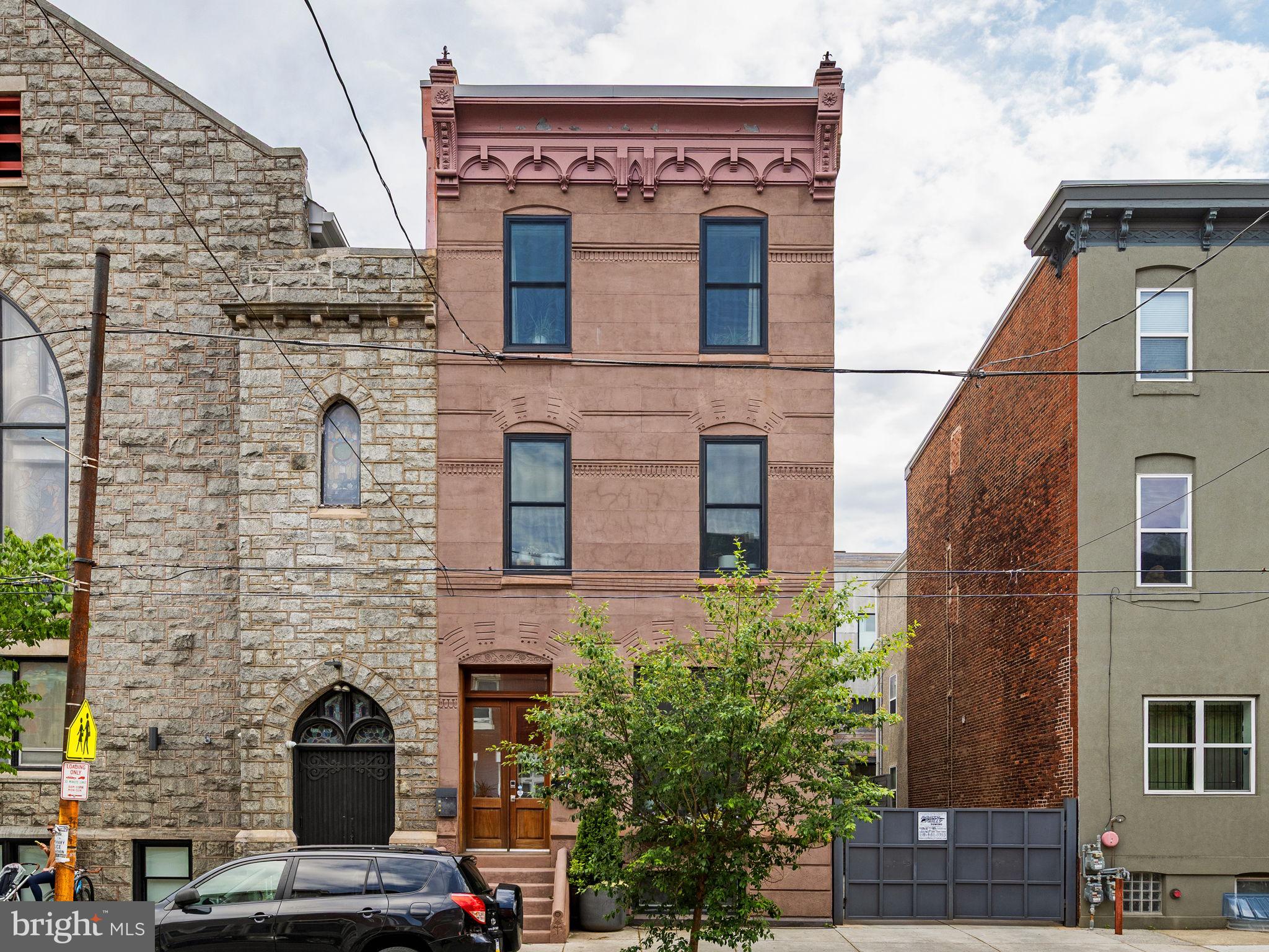 Set on an expansive 30+ foot-wide lot along one of Graduate Hospital’s most sought-after blocks, 1608 Christian Street is a striking brownstone that blends architectural presence with modern livability—anchored by seamless indoor-outdoor flow and the everyday ease of attached two-car parking.

From the moment you enter, the scale is undeniable. Soaring  12-foot ceilings on the main level and oversized proportions create an airy, gallery-like quality rarely found in city living. The layout unfolds with intention across multiple levels, designed to support both daily life and elevated entertaining.

The main level is both polished and practical. A generous living room with a gas fireplace flows into a defined dining area and a beautifully appointed kitchen featuring an oversized island with seating for six, high-end appliances (Wolf, SubZero), custom cabinetry, and stone countertops. Just beyond, a large terrace extends the living space outdoors—ideal for morning coffee, casual dinners, or hosting with ease. A powder room and a thoughtfully designed mudroom with direct access to the terrace and parking complete this level.

The second floor opens into a spacious family room—an inviting, flexible setting for movie nights or quiet retreat. The adjacent primary suite is expansive, with a custom-outfitted walk-in closet and a spa-like bath featuring marble floors, a double vanity, a freestanding soaking tub, and an oversized glass-enclosed shower with dual showerheads. The bedroom is filled with natural light from south- and west-facing windows and offers space for a sitting area or office.

The third level includes two generously sized bedrooms and bathrooms, along with a well-appointed laundry room and a hall kitchenette complete with a beverage refrigerator, sink, and dishwasher—an elevated convenience rarely found.

Floating stairs lead to the roof deck, complete with an outdoor kitchen and sweeping skyline views—designed for entertaining at every level, from intimate evenings to larger gatherings.

A finished lower level with a powder room further expands the home’s versatility, ideal for a media room, fitness space, or guest overflow.

Throughout, the home is fully integrated with smart technology, including automatic bedroom blinds, a security system with electronic entry, app-controlled lighting and thermostats, and a Sonos sound system with multiple zones and surround sound in the main living area.

Positioned within the historic Black Doctors’ Row, the home is part of a culturally significant corridor that once housed a remarkable concentration of Black physicians and professionals—adding a meaningful layer of legacy to an already exceptional address. Originally the rectory to the former First Baptist African Church, 1608 Christian has been thoughtfully reimagined by the design team that transformed the neighboring historic church into The Deacon, a luxury event space & hospitality venue.

Just beyond your door, the best of the city is within reach—Rittenhouse Square, Italian Market, Queen Village, and Passyunk Square are all within a 15-minute walk—along with neighborhood cafés, restaurants, and daily conveniences. Nearby grocery options, including GIANT Heirloom Market, Sprouts Farmers Market, and Target, round out the neighborhood experience.

Two years remaining on the 10-Year Tax Abatement.