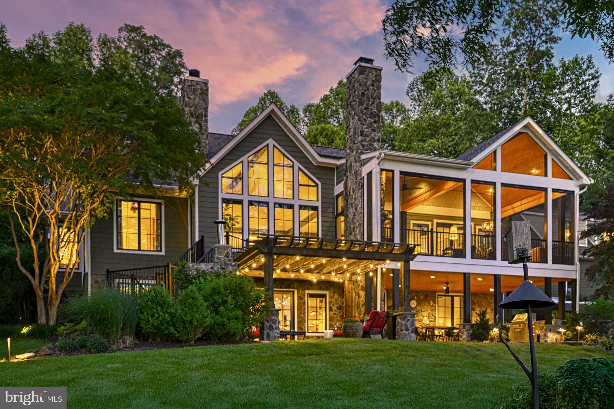 Prepare to be captivated. This is not just a home—it’s a statement. A true waterfront masterpiece on the public side of Lake Anna, where luxury, design, and nature come together. Every inch of this property has been thoughtfully curated, recently renovated, and elevated to offer one of the most impressive lakefront living experiences available today, and there is NO HOA!

Set on over an acre of lush, mature landscaping, this custom-designed estate welcomes you with a paved driveway, detached two-car garage with finished living space above, and a setting so private and serene it feels like your own resort. Step inside and you're greeted by panoramic lake views through oversized black double-pane windows and doors. The heart of the home is the custom gourmet kitchen, finished with premium cabinetry, fixtures, and design features that rival high-end new construction.

The main level showcases timeless hardwood floors, a dramatic rock fireplace with built-in shelving, and luxurious multi-panel bi-fold patio doors that open to a stunning screened-in porch featuring a wood ceiling, custom tile flooring, and a wood-burning fireplace. The primary suite is a retreat in itself, offering private access to the porch, a spa-inspired ensuite bathroom with a walk-in shower, and a professionally designed Elfa closet system. Two additional bedrooms and a full bathroom complete the main level.

Downstairs, the luxury continues with two additional bedrooms, a full bathroom, large laundry area, a naturally temperature-controlled wine room, and abundant storage. The lower level walks out to an unforgettable outdoor living space, featuring a covered kitchen, pizza oven, and custom dining patio perfectly positioned to take in wide water views.

The detached structure offers a two-car garage on the main level, with a fully finished private suite above that serves as the home’s sixth bedroom. This versatile space is beautifully designed and can function as a bedroom, office, gym, or additional living area. Complete with a cozy sitting area, fireplace, full bathroom, wet bar, and stunning views of the water, it provides a comfortable and stylish retreat completely separate from the main residence.

Follow a landscaped path past a playground and hammock area to your private dock—an entertainer’s dream—with two covered slips with electric lifts, a bar and seating area, a sun deck, storage, and an upgraded seawall. This is where the lake lifestyle comes alive.

Built for comfort and engineered for performance, this home includes tankless water heaters, heated bathroom floors, whole house water filtration, a whole house generator, common-sense electrical upgrades, smart home integration with lighting and irrigation, and a full Cat 6 mesh network. FiberLync fiber internet is installed, with Wi-Fi extended to the dock. The garage includes an EV charger, and every upgrade reflects intentional, luxury-driven choices.

Whether you're searching for a primary residence, a high-performing vacation rental, or a weekend escape, this property delivers. Properties like this rarely come available. This is your opportunity to own one of Lake Anna’s most extraordinary waterfront homes.  All outdoor furniture and 2 bedroom furniture sets can convey. Waterfront in ft is approximate +/-.

Contact us today to schedule your private tour. See for yourself what luxury at the lake truly looks like.
