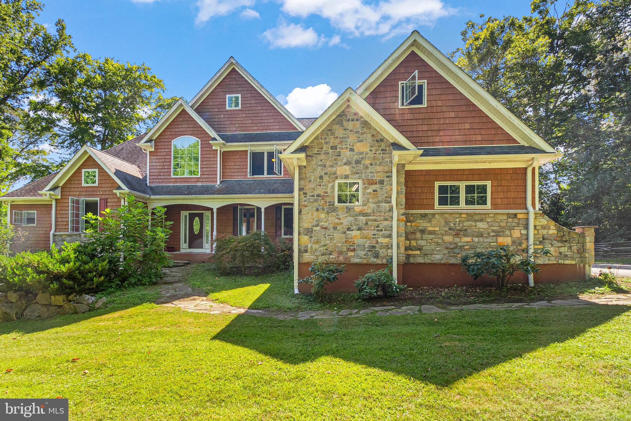 Please watch the beautiful drone video of this wonderful property!
Welcome to your dream home!  This stunning French Traditional home, custom-built by the original owners with numerous upgrades, is right in the heart of the award winning Unionville-Chadds Ford School District.  Tucked away on 2.8 peaceful acres next to Pocopson Park Trail, it's the perfect spot to enjoy your morning coffee while soaking in the beautiful views and gardens.  Step inside to find gorgeous hardwood floors and a chef's dream kitchen.  The kitchen features a huge granite island, a professional commercial range, pot filler, double ovens, and a built-in microwave that even grills!  There's plenty of storage with an oversized pantry, two dishwashers and two built-in trash bins to make clean up easy.  The open floor plan is great for entertaining with a double-sided gas fireplace connecting the kitchen and family room, plus a formal dining room for larger gatherings.  The main level also includes a spacious Primary Bedroom with amazing views through oversized windows and a private patio entrance.  The en suite bath has a soaking tub, spa shower, his and her closets, and a laundry room.  There is also a large office just outside the Primary Suite.  Head up the formal staircase and overlook the bright and airy two-story Family Room.  The upper level features three large bedrooms, each with their own bath, a second laundry room, a loft office, and a huge storage area that you can finish if you choose.  The fully finished basement adds an extra 2,900 square feet of living space.  It includes a wine cellar, a workshop for hobbies or carpentry with its own 100-amp circuit breaker box, an open recreation room with an island, more storage, full bathroom, and two other rooms to utilize however you choose.  Leave it to your imagination!  Step outside from the basement to relax in the spacious hot tub.  This home also comes with a dual geothermal system for heating and cooling, which is a huge energy saver and a green feature.  There is plenty of space for your cars with a four-car garage and a 10' x 24' shed for garden tools and equipment.  Enjoy low maintenance living with easy access to Philadelphia, Delaware and New Jersey.  You're also close to local attractions like Longwood Gardens, Brandywine River Museum, Brandywine Battlefield, and the charming towns of Kennett Square and West Chester, which have some of the best restaurants and shopping around.  This home offers luxurious and easy living in a fantastic location.  Don't miss making this your new home!