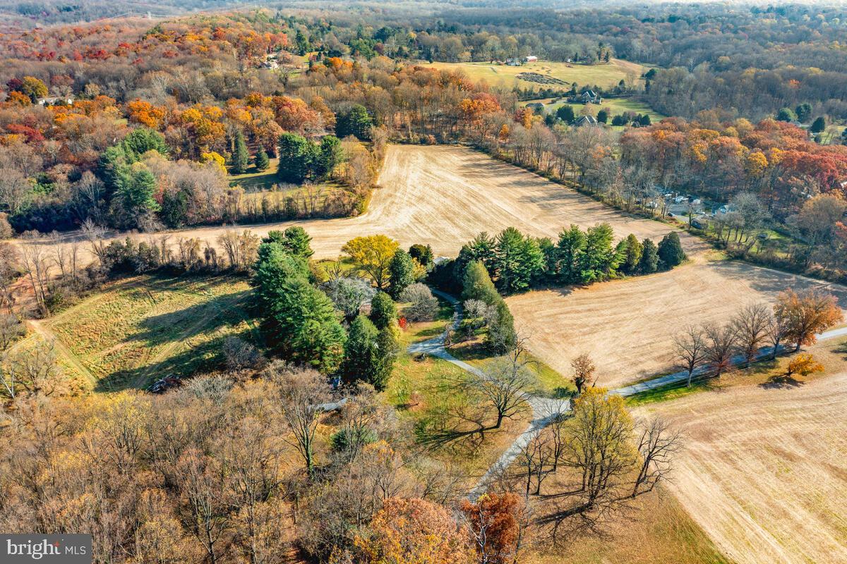 OFFER DEADLINE WEDNESDAY, NOVEMBER 29TH AT 4:00PM
PLEASE NOTE: DO NOT DRIVE ON LAND WITHOUT AN APPOINTMENT! MUST HAVE AN APPOINTMENT SCHEDULED BEFORE SHOWING OR DRIVING ON PREMISES.

Approaching the residence, you're greeted by the promise of renewal amidst the serene landscape. 
Nestled on a sprawling 14.3-acre parcel, this property presents a captivating opportunity to reimagine and revive a 4-bedroom, 4-bathroom home, accompanied by two barns. Envisioned as a canvas for your creative vision, this home holds immense potential for transformation. Venturing outdoors unveils the vast potential of the expansive land, offering the canvas for myriad possibilities. Whether it's restoring the grounds to their former glory, creating lush gardens, or exploring recreational pursuits, the landscape beckons with opportunity. This 14.34 acre parcel must be purchased with the adjacent 5.81 acre parcel
 ( See MLS MCMD2113856)l for a combined full 20 acres. 14.354 is $625,000 and 5.8 acre is $320,000. If you don't want to renovate you can subdivide the 20 acres into 4 lots. If you subdivide you would need to add a new road off of Mink Hollow.
PLEASE CALL LA WITH ANY QUESTIONS. PROPERTY IS BEING SOLD STRICTLY AS IS