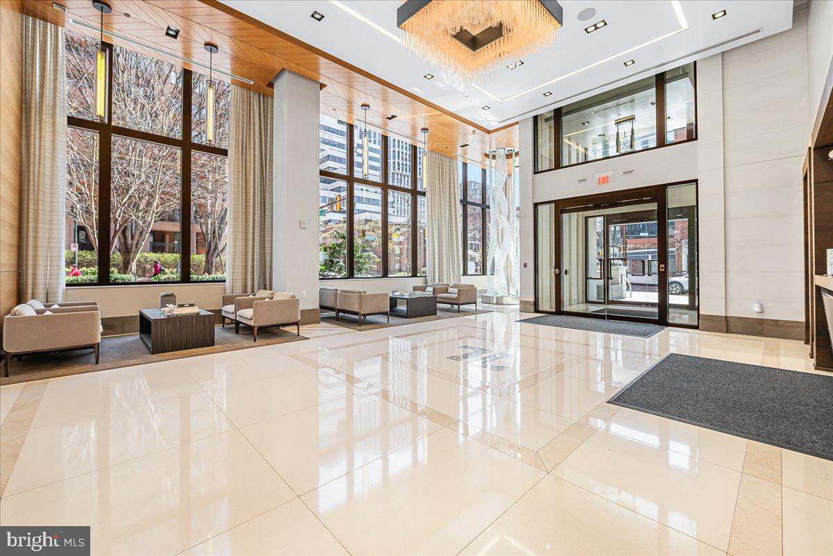 Unit 203: Where Boutique Luxury Living Meets Downtown Ease.  Unit 203 offers a perfect balance of privacy and presence in the heart of Downtown Bethesda. Spanning close to 2,200 square feet,  this expansive two-bedroom, two and half bath unit with den, features a whisper-quiet elevator that opens directly into your foyer. The rooms and the open living area are large and spacious. The chef’s kitchen features professional-grade appliances by Wolf and Sub-Zero. You will love the owner's bathroom, with its double sink vanity, soaking tub, and separate shower. A versatile den features a discreet "hidden desk" for the modern professional. A dedicated, oversized laundry room is equipped with full-size Whirlpool appliances and a deep utility sink. Two premium parking spaces with EV charger are situated just steps from your private elevator portal for effortless entry and exit. This is more than a residence- it is a testament to refined urban living. Amenities at The Lauren include:  private fitness studio, rooftop terrace, and private lounge for entertaining family and friends.  The peace of mind provided by the 24-hour concierge, the on-site maintenance manager, and the building manager makes living at The Lauren more than a home—it defines luxury like no other.