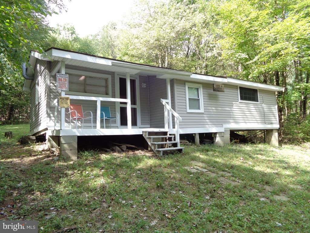 Small primitive cabin w/electric recently added located on 66+ acres that extends to peak of Jacks Mountain where 911 tower is located along Jacks Mountain Road.  Spring on property.  Pit privy (outhouse) no indoor plumbing.  Cabin is furnished with basic furniture, beds, appliances.  Has electric wall heater plus woodstove.,552 Sq.Ft., Cabin(Bldg1_Desc),Frame(Bldg1_Constr),Fair(Bldg1_Condition),Wood(Bldg1_Floor),Shingle(Bldg1_Roof)