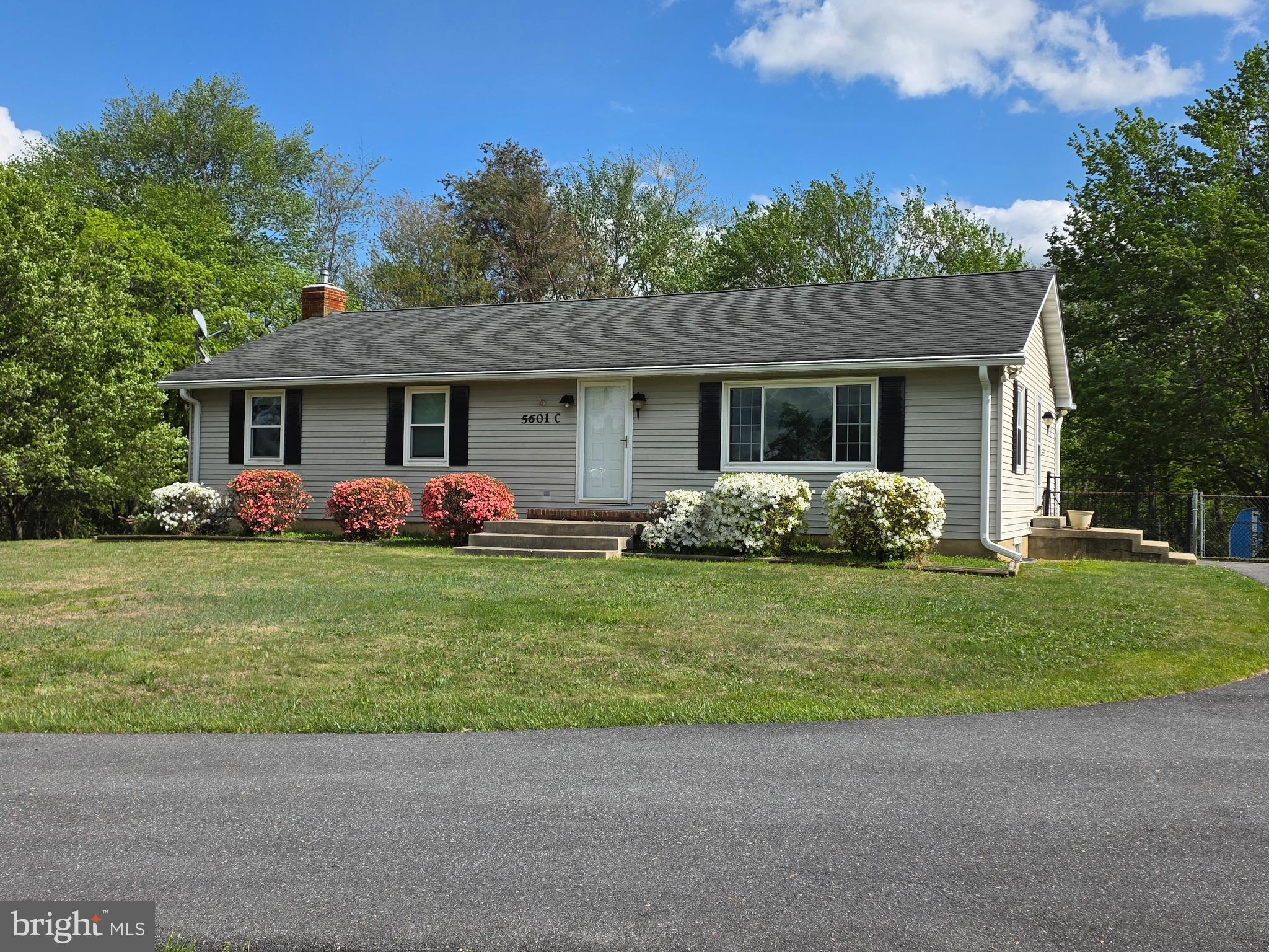 Over 2500 SF of living space on two finished levels!! Welcoming 3BR 3FB ranch home situated on a beautiful 1.32 acre level lot, backing to mature, leafy trees!  Updated eat-in kitchen with space for an extended dining table, large island with room for four bar stools, and lots of counter space for all the family cooks!  Very comfortable living room with bright picture window and gorgeous  views of the sunset and cows grazing on the farm across the road.  So much natural light!  The primary suite accommodates a king-size bed,  with plenty of room for large furniture, and includes a  walk-in closet and private bath.  The finished lower level features a  family room with woodstove, walk-out to the acre-plus property, and a spacious  laundry room with lots of storage, a workbench, folding table and hanging racks,.  There's an XL bonus room with closet, small counter space and cabinet, and an adjacent full bath,.  This family had the lower level set up as  a teenager's retreat, then as an in-law suite with microwave and mini-fridge,  Ideal for a studio or home gym, even a theatre room. The possibilities are endless.  There's a chair lift to basement (new last year) if stairs present a challenge. The stair chair can convey, or be removed if desired.  The cherry on top is the extended covered deck off the kitchen ... a sweet spot for morning coffee, summer dining, even working at home or just hanging out and enjoying nature all around you.   There's a fenced area in the rear yard to contain  little ones or furry friends, plus two big sheds for outdoor storage.   Add a sports area, a vegetable garden, a firepit ... maybe even a garage on this picturesque level lot with a country feel, just minutes away from everything in Mt. Airy.  Imagine your future here ...Come live the dream!!