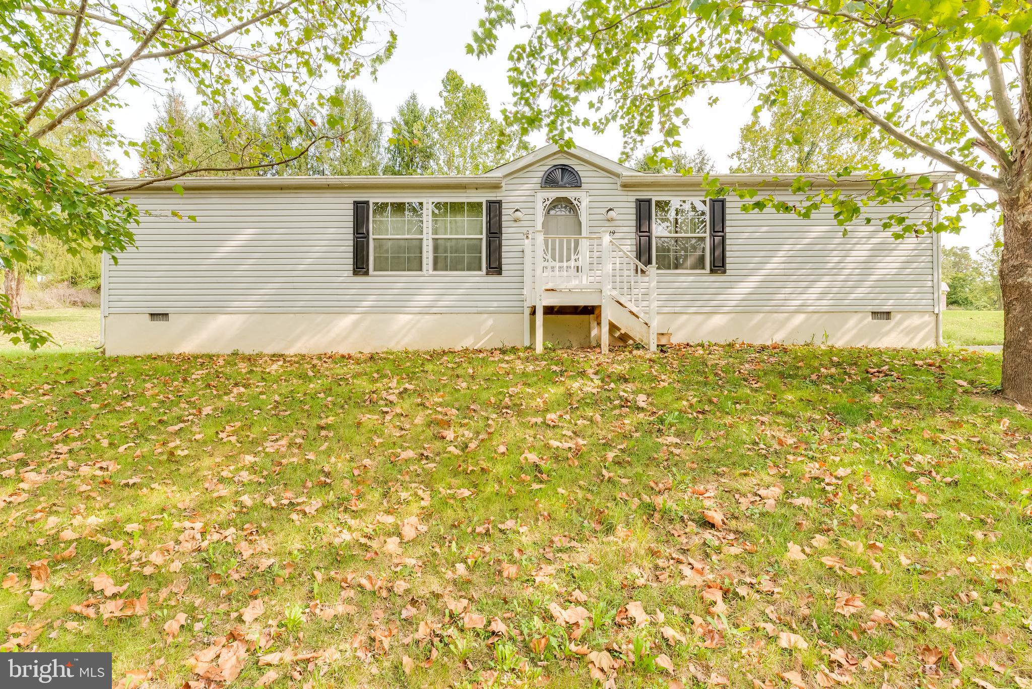 Enjoy the peaceful surroundings of this home near the Opequon Creek. Be sure to pack  your fishing rods and outdoor sporting equipment. This 2006 double wide sits on a  permanent foundation with a crawlspace. Featuring a  large kitchen with an island, spacious living room, owner bath with separate garden tub and shower, this property offers a great deal of potential. The large lot of .79 acres sits atop a hill with a paved driveway and outdoor shed with a concrete floor.  Convenient gutter guards were installed in Oct 2019 for ease of maintenance.  Mature trees create privacy and enjoyable views.  Plenty of room to garden or spend your days soaking up the sun.  Schedule your visit today and make this your home.