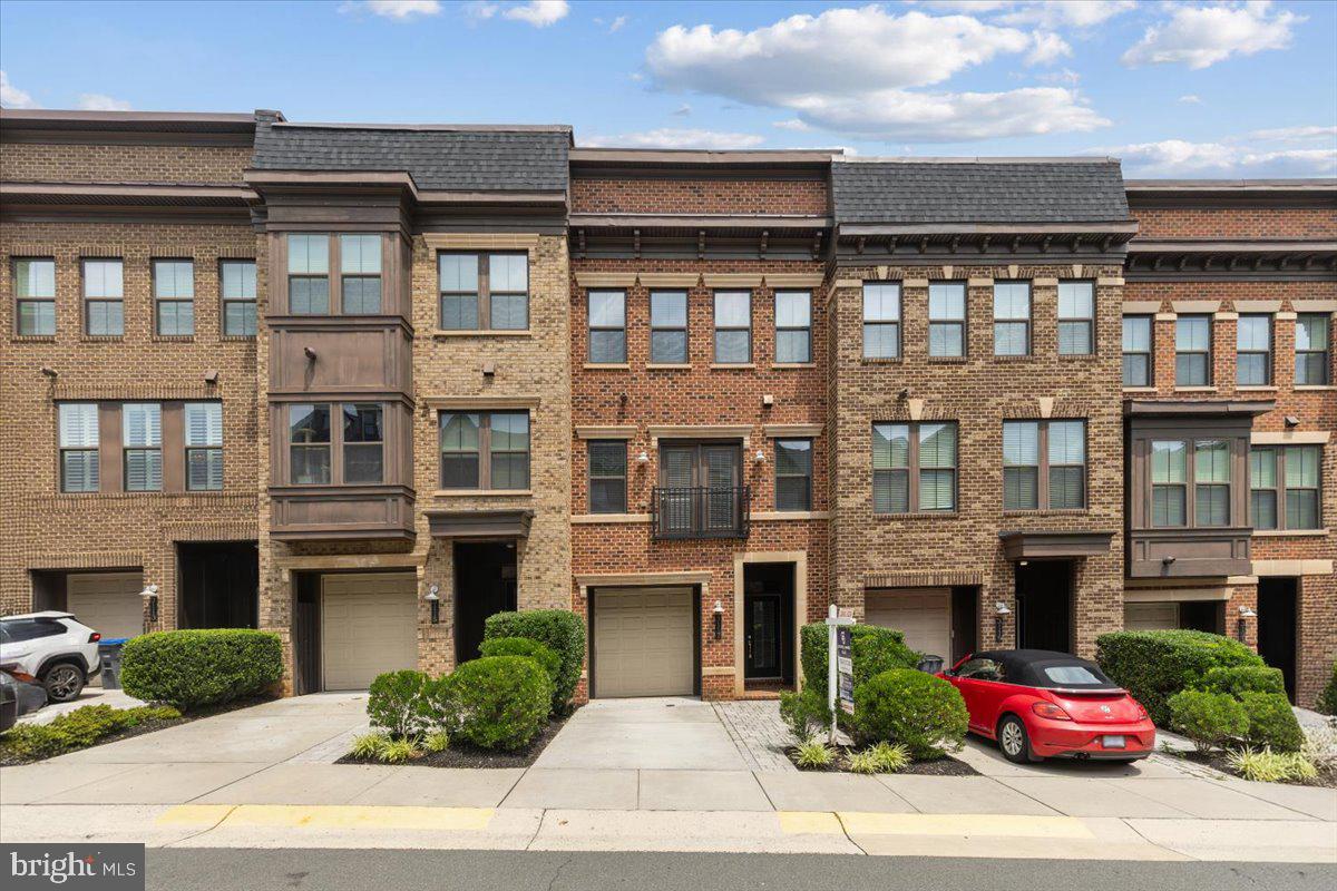 Welcome to this exceptional gem in the sought-after Metro Row community, offering stylish living, thoughtful upgrades, and an unbeatable location within a highly rated school pyramid. The expansive floor plan features an upper level with three bedrooms, including a luxurious owner's suite with two walk-in closets, a convenient laundry area, and two additional storage closets. The light-filled main level is designed for effortless entertaining with an open-concept layout featuring a spacious kitchen with a large center island, room for a full dining table, two oversized pantries, a powder room, and a large deck with a natural gas hookup for easy grilling. The lower level offers exceptional flexibility as a guest suite or recreation room, complete with a full bathroom, direct access to the fully fenced private backyard, and two additional storage closets. A unique elevator shaft, currently finished as expansive storage on every level, offers the opportunity for future elevator installation if desired.
Meticulously maintained, this home is loaded with premium upgrades, including a custom-built bar with beverage refrigerator, a queen-size Murphy bed with built-in shelving and drawers in the lower-level bedroom, ceiling fans in all upstairs bedrooms, professionally installed hidden cable management and power outlets for wall-mounted TVs in both the family room and lower-level bedroom, a new dishwasher (2025), built-in surround sound speakers, two Nest thermostats, and a Ring doorbell. The HVAC system has been professionally inspected and serviced twice annually, with an Aprilaire whole-home humidifier added in 2021, a new A/C start kit installed for improved energy efficiency in 2026, and a complete interior and coil cleaning of the air conditioning system completed in 2026.
Outdoor improvements include a fully fenced backyard (2022), a newly added 8' x 6' patio (2025), and direct access from the lower level, creating an ideal space for pets, play, or entertaining. The attached garage is equally impressive, featuring a 240-volt outlet for EV charging (2024), an 8' x 4' overhead storage rack for additional storage, driveway parking, and ample on-street guest parking.
The HOA provides exceptional value by covering lawn care, landscaping, sewer, trash, and snow removal. Perfectly situated in the desirable Metro Row neighborhood, this home offers easy access to shopping, dining, parks, and major commuter routes. You're just minutes from Vienna Metro Station, Mosaic District, downtown Vienna, Tysons, Fairfax Corner with Wegmans, INOVA Fairfax Hospital, George Mason University, and Dulles International Airport. Combining an outstanding location, excellent schools, and an impressive list of upgrades, this move-in-ready home is a rare opportunity not to be missed.
