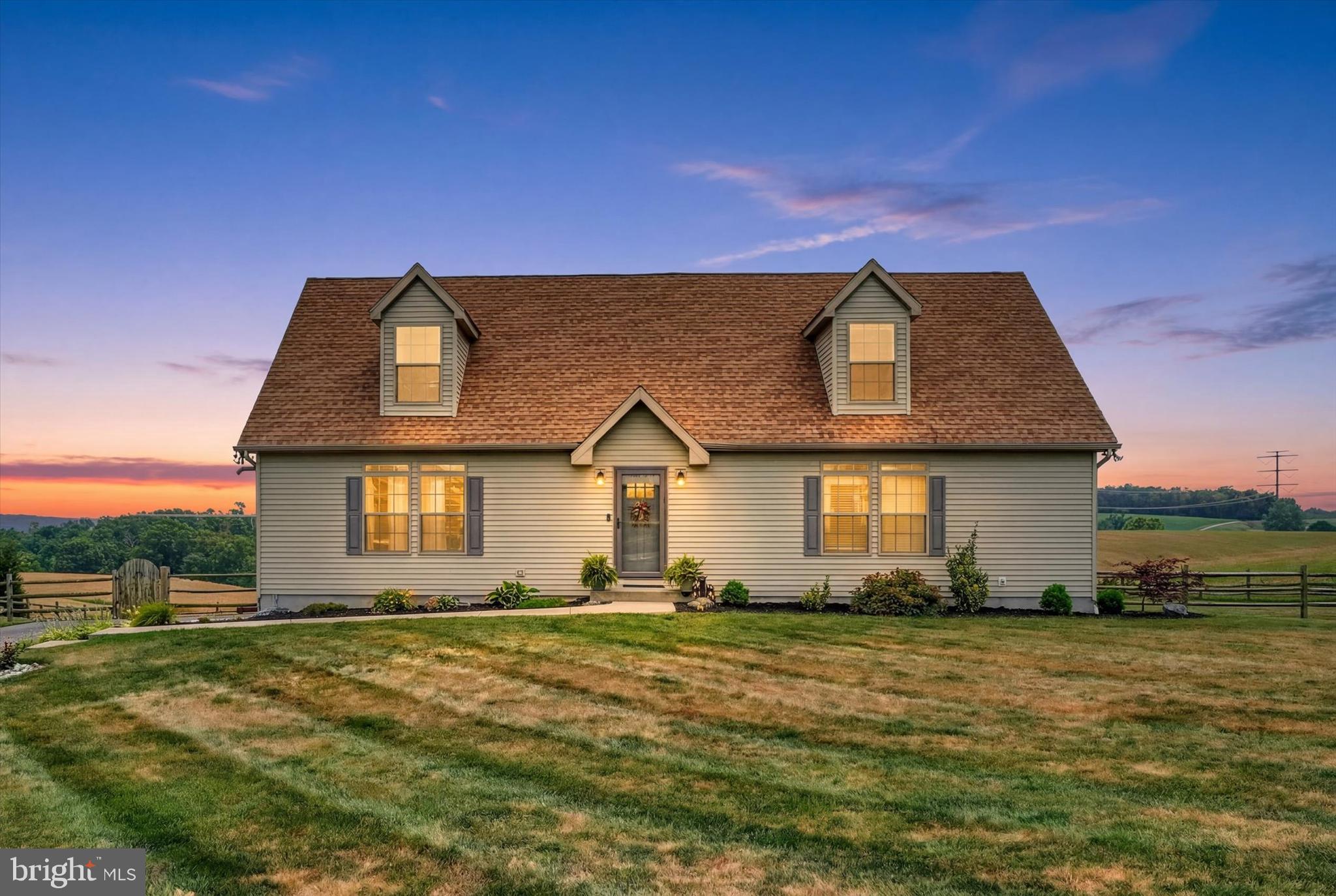 Location, location, location! This gorgeous, turn-key 4 bed, 3 bath Cape Cod home is situated on a scenic, level 1 acre lot with panoramic views of the beautiful surrounding rural landscape. The well-designed layout blends an open feel with functionality and comfort, which has been designed for the option of one-level living, and enhanced by many quality upgrades throughout, including elegant crown molding and decorative columns, durable and stylish luxury vinyl flooring in the main living areas, large transom-top windows, a cozy pellet stove in the living room, smart storage features and more. The bright entry foyer with two handy coat closets opens into a huge living room flowing smoothly into the sun-kissed kitchen and dining room area, which boasts solid wood cabinetry and stainless steel appliances. Two first floor bedrooms include a primary suite with full private bath and walk-in closet, and a second bedroom served by the full main bath. A convenient laundry room with built-in cabinetry completes the first floor. Upstairs two additional generous bedrooms with large closets and dormer windows are served by a third full bath. The full Superior Wall foundation with walk-up exit is ready for your storage needs or easily finished for additional living space. Outside, the exceptional lot is level and clear, with a fenced backyard, fire pit area, oversized storage shed and ample room for your favorite activities, or your outdoor oasis design ideas. The wonderful open and natural setting feels remote, but is only minutes to Routes 851 and 24, Shrewsbury and the PA/MD, so you don't have to sacrifice convenience for peace and quiet. Welcome home!