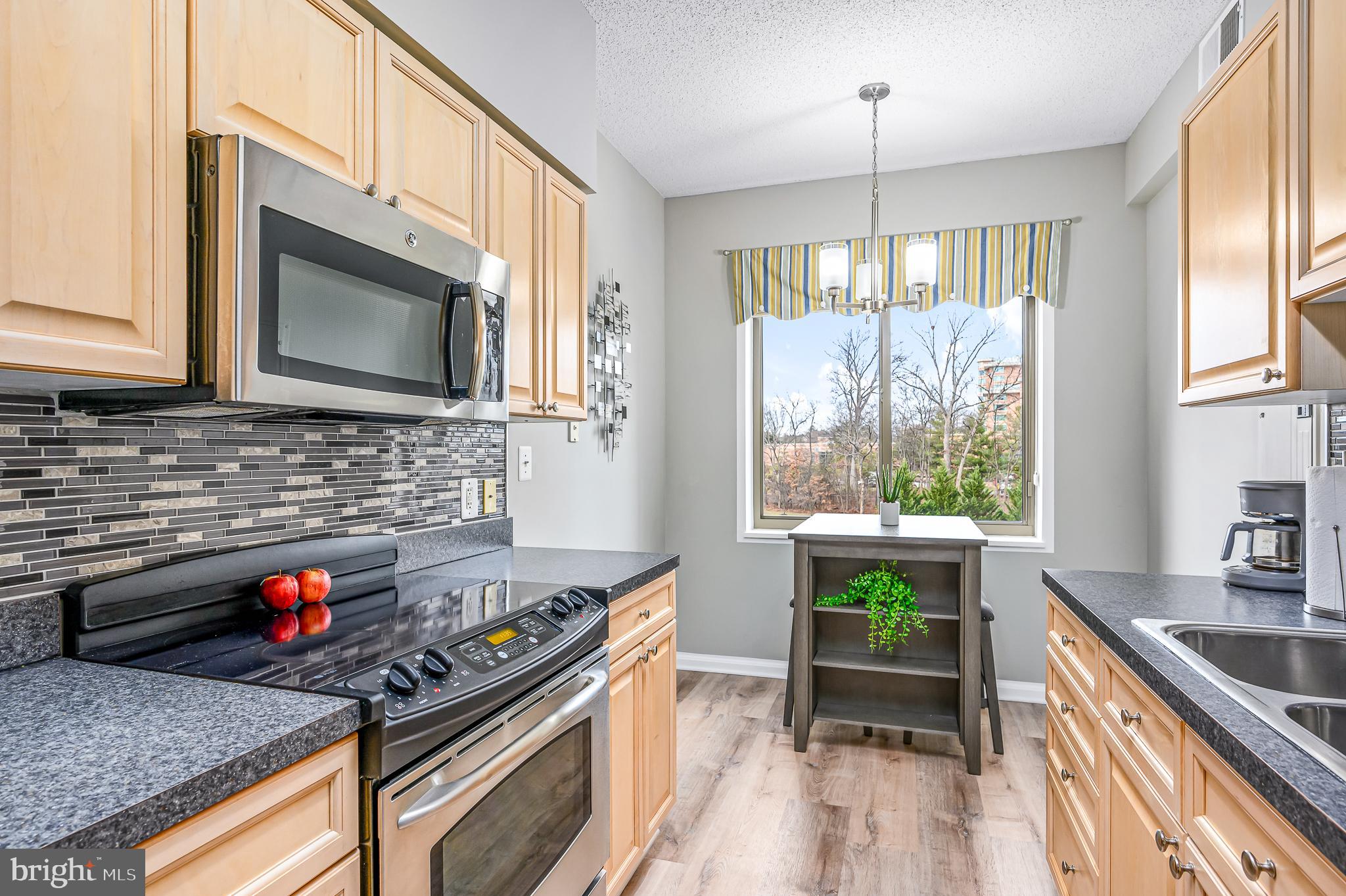 Prepare to fall in love with his move in ready condo with  an eat in kitchen which includes a window that adds lots of light, stainless steel appliances and plenty of room to work and store items.   The  spacious living room is just steps away from a  glass enclosed balcony with screened windows  that can be opened to allow  in the breeze and sounds of nature.   This home also has a separate dining area  with  plenty of space for your cherished furniture.  The ensuite main bedroom/bathroom includes a step in shower and lots of closet space.  The condo  has a 1/2 bath as well.

The current owner has meticulously maintained  this beautiful condo and you will be impressed with the updated touches, light and open space and attention to detail

The Lansdowne Woods community includes a large and active clubhouse which has pool, fitness, tennis and pickleball courts, art studio, woodworking shop, restaurant, ballroom, billiards and  more.  Outside of the clubhouse there are walking trails, large green spaces in which to relax and outdoor garden plots for residents to utilize.  There are too many clubs and activities to list here and we encourage you to explore the variety of options.

Schedule a time to look at this  special home and you won't be disappointed.