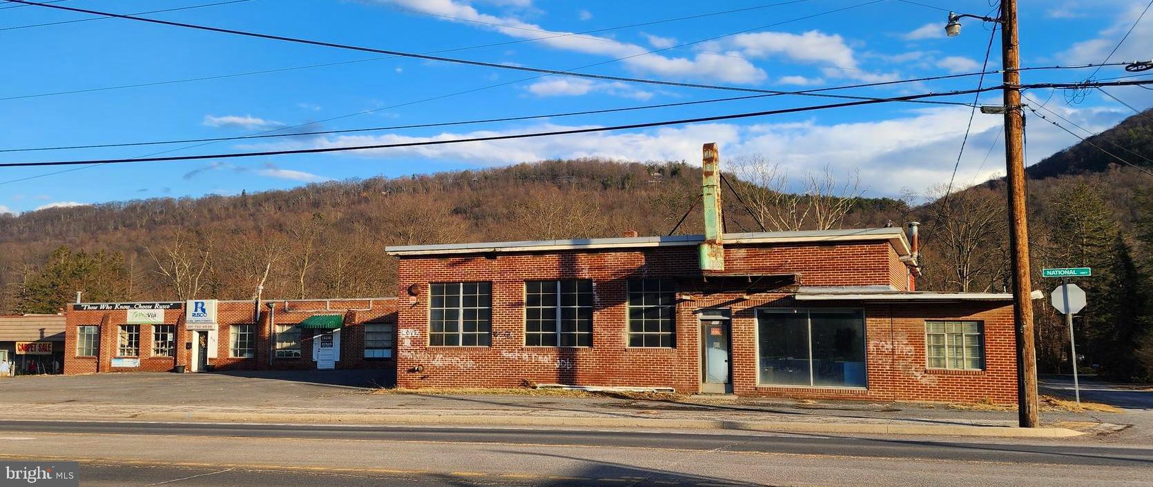 In the heart of LaVale, this property boasts of with two buildings on 3 parcels comprises .80 acre, main building is made up of of 3 sections currently 2 tenants with a total of 8,203 sf and a 2nd building consiting of 3 garages for 2,000 sf, the building was designed for operational flexibility, together, this property seems well-suited for commercial or mixed-use purposes.  Plenty of parking spaces.  Renovate or build your new within this high traffic area.  Adjoining property sold separately which will include a full block of the commercial area.