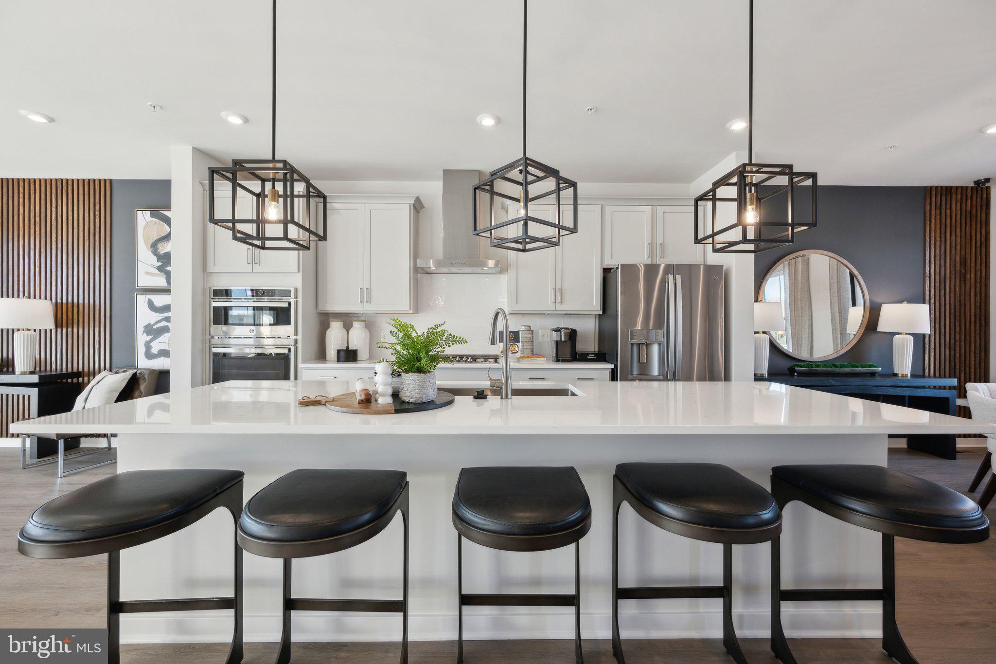Welcome home to the highly sought-after Delilah floor plan, a stunning end-unit townhome offering the perfect blend of style, space, and functionality. Featuring 3 bedrooms, 3 full bathrooms, and 1 half bath, this beautifully designed home spans three finished levels and is loaded with upgrades.

The main level showcases an open-concept layout ideal for modern living and entertaining. The impressive gourmet kitchen features the elegant Inspired C Design Package, complete with luxurious white cabinetry, designer finishes, abundant storage, and a spacious center island overlooking the dining and living areas.

Step outside to your deck, perfect for relaxing, entertaining guests, or enjoying your morning coffee.

The finished lower level includes a full bathroom, offering endless flexibility for a guest suite, home office, fitness area, or recreation room.

Enjoy the convenience of a 2-car garage plus driveway space for 2 additional vehicles, providing parking for up to four cars. As an end-unit home, you'll appreciate the added privacy, extra windows, and abundant natural light throughout.

Located in the desirable Overlook at Westmore community, residents enjoy convenient access to shopping, dining, major commuter routes, and community amenities.

This is your opportunity to own a brand-new luxury home that combines sophisticated design, spacious living, and exceptional convenience. Schedule your private tour today—this exceptional end-unit won't last long!