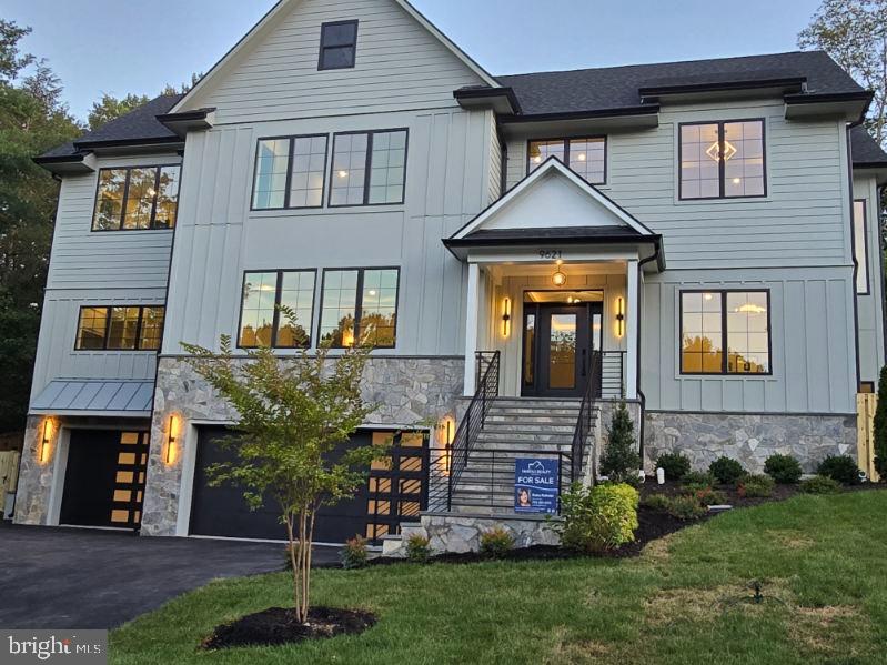 New construction home in Great Falls 10 min from Tysons, Large 1/2-acre corner lot with lots of space. 3 finished levels almost 7k SQFT....Walk up the beautiful stone stairs to the Large 9" door to an elegant entryway with herringbone pattern wood floors. 10” ceilings on all 3 finished levels. Dining room to your left has a double-sided fireplace facing the family/ living room. spacious dining room with high ceilings and a grand design, in a warm green color, sconces over the see through fireplace. To your right you find two glass pocket doors to the home office or formal living room, with chandelier.  Front of the entrance is a door that leads to the main level owners' suite with washer and dryer on main level.  Wide stairs going up and down all 3 levels.  drop down chandelier in hallway up to the loft.  Past the dining room is the huge family room off the kitchen with vibrant ceiling lights.  kitchen has a hidden prep kitchen connecting the dining room / butler’s pantry/ kitchen.   Oversized Quartz countertop, two ovens, microwave convection oven, 8 burner professional stove, with griddle.  Lots of cabinets to the ceiling, Island can seat 6 comfortably.  Great for entertaining.  Off the family room's double glass sliding doors the outdoor room boasts a two-way fireplace great for outdoor entertainment, large fan, tile flooring and iron railings.  lots of light for outdoor cooking.   the upper level has a Loft area is great for kids or just relaxing in the mornings. Laundry room space for two machines and lots of cabinets, storage area for hampers plus a sink and shelves. # large rooms w/own bathroom.   UL owners' suite has a soaking tub and two shower heads with modern vanities and lighted mirrors. his and her closet, sconces and fand in room.  Walk up basement access to back yard. Robust basement bedroom with walk modern classy shower tile, half bath for guest use and more storage, mud room off the 3-car garage. Theatre or exercise room with projector pre-wired.   Private fence around the back of the property, two large gates on each side.  Whole home pre-wired for Internet, and pucks on every floor. Custom tile showers in every bathroom.  Custom stonework Hardy Magnolia siding.    All rooms with on-suits and walk in closet, 2- 1/2 baths on main level and one in basement.   Langley school pyramid...  1 year builders’ warranty and 5-year structural warranty.