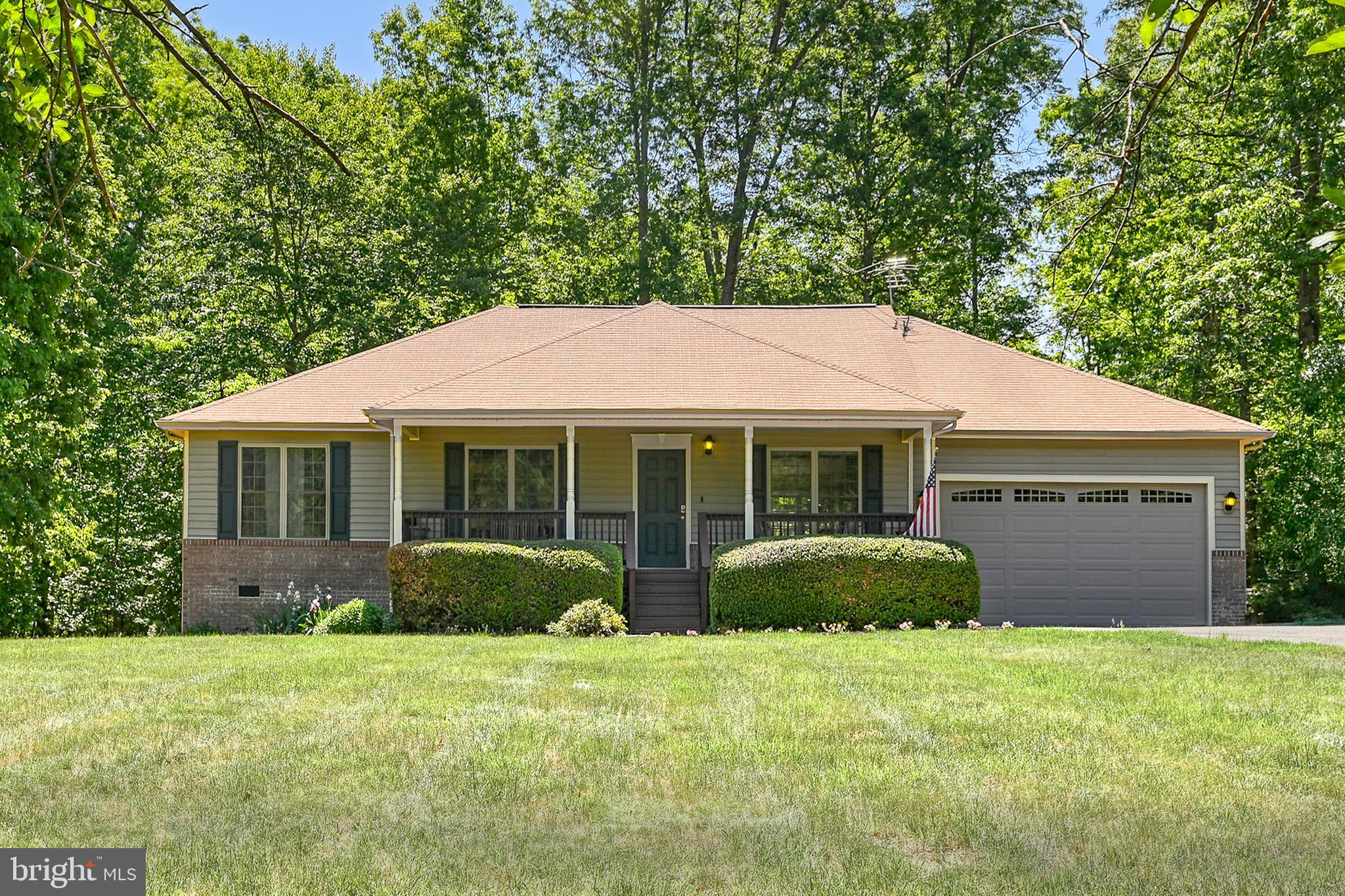 Welcome to easy lake living in the amenity-filled Windwood Coves community on the public side of Lake Anna! This well-maintained 3-bedroom, 2-bath one-level home offers the perfect combination of comfort, convenience, and outdoor enjoyment — all situated on a beautiful flat lot in a golf cart-friendly neighborhood.

Inside, the comfortable living area features a gas fireplace and vaulted ceiling detail that adds an open and inviting feel to the main living space. The functional floor plan also includes a dedicated laundry room and an additional flex space that would make an ideal home office, workout room, hobby space, or guest overflow area. Fiber optic internet is available, making remote work and streaming a breeze.

From the moment you arrive, you’ll appreciate the paved driveway, attached 2-car garage, covered front porch, mature landscaping, and inviting curb appeal. The spacious rear deck creates the perfect setting for entertaining, summer cookouts, or relaxing evenings around the dedicated firepit area. The property also features four apple trees, a storage shed, RV hookup, whole-home generator, and EV charger in the garage for added functionality and peace of mind.

Best of all, deeded boat slip #257 conveys, giving you quick access to enjoying life on the lake. Windwood Coves offers an impressive lineup of amenities including a sandy beach, boat launches, tennis courts, basketball court, volleyball area, picnic spaces, playground, and more — making every day feel like a getaway.

Conveniently located near local restaurants, wineries, grocery stores, and popular Lake Anna attractions, this property is ideal as a full-time residence, weekend escape, or investment opportunity. If you’ve been searching for low-maintenance lake living with community amenities and boating access, this one is worth a look!