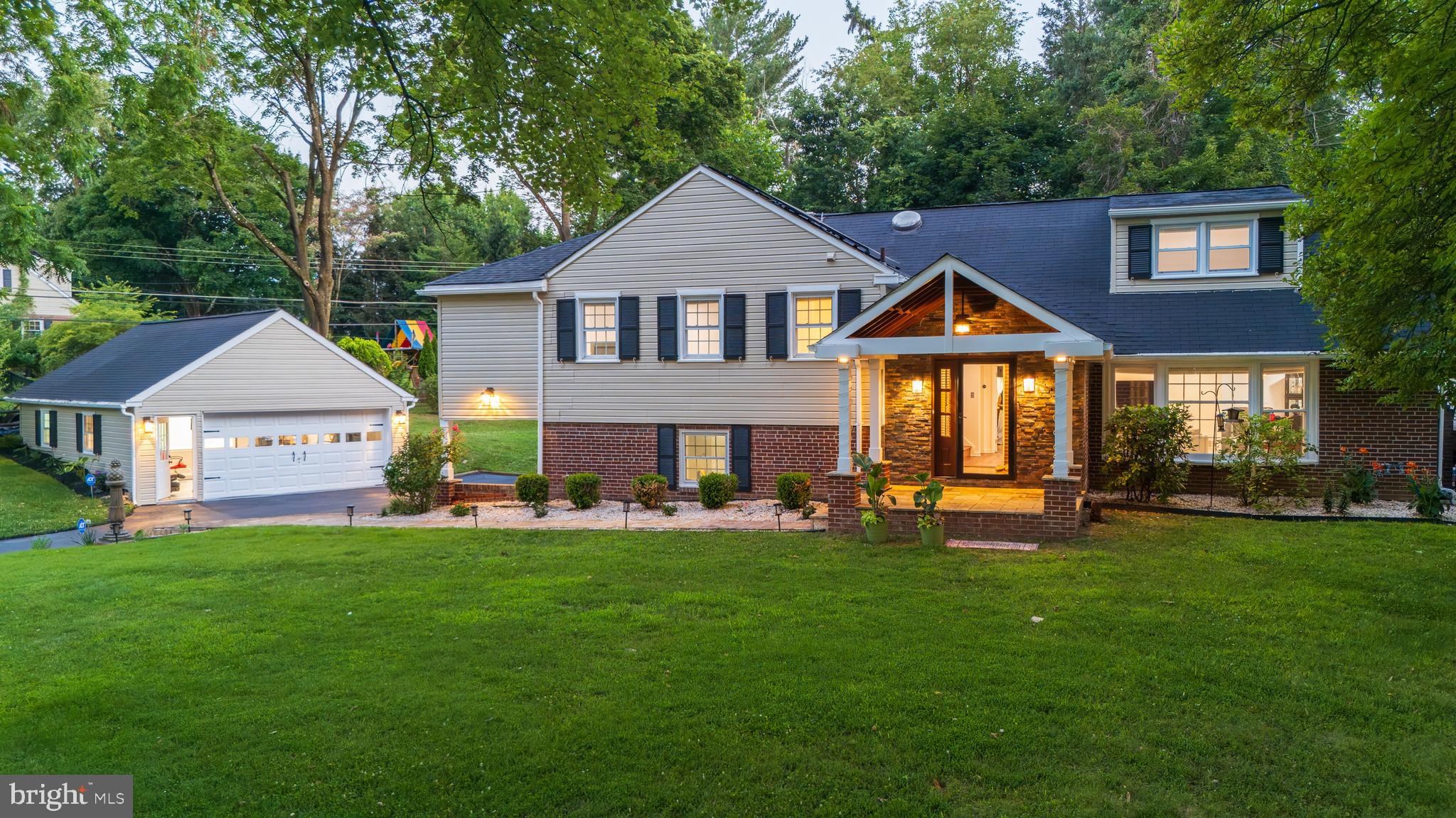 Welcome to 1291 Thomas Rd, an absolutely gorgeous updated and expanded home set on a premium lot in the coveted Glenhardie neighborhood of Wayne. Offering more upgrades than can possibly be listed here, highlights include TWO 2-car garages, a fenced rear yard with a gorgeous in-ground pool, extensive hardscaping, a private home office, and five beautifully finished living levels, located in the top ranked Tredyffrin-Easttown School District. The covered front porch opens to a welcoming entrance hall featuring hardwood flooring, exposed brick, and a skylight that fills the space with natural light. The spacious living room offers a wood-burning fireplace flanked by custom built-in shelving and flows seamlessly into the formal dining room. The beautifully renovated kitchen is the heart of the home and features tons of raised-panel cabinetry with display cabinets, gleaming granite countertops and center island, a handsome tile backsplash, stainless steel appliances, and a skylight. A doorway leads directly into the spectacular four-season sunroom. The sunroom is a true showpiece, offering tile flooring, exposed beams, a ceiling fan,  skylights, and three sliding glass doors. One opens to the side yard, another to the pool area, and the third leads to the new deck featuring a retractable trellis awning, all overlooking the rear grounds and in-ground pool. The second level features hardwood flooring throughout and is highlighted by the sumptuous owner's suite which offers a sun tunnel for additional natural light, two walk-in closets—each with its own skylight—plus an additional double closet. The beautifully renovated en-suite bathroom features a granite-topped vanity and an oversized steam shower. Two additional generously sized bedrooms complete this level. Bedroom two features a wonderful homework or home office bump-out along with its own sun tunnel and a walk-in closet. Bedroom three has a corner location and features a double closet.  The beautifully updated hall bathroom features custom tile work and a tub/shower combination. As an added convenience, a second washer and dryer are located in the hallway on this level. The third floor serves perfectly as a private fourth bedroom, guest suite, or second owner's retreat. It offers generous closet space and a beautifully renovated full bathroom featuring tile flooring, a spacious shower, and custom tile detailing above the vanity. The driveway level has been thoughtfully redesigned into an exceptional mudroom, creating a seamless transition from the attached two-car garage and side driveway. Tile flooring, multiple cubbies and great closet space, a beautifully renovated powder room, and a well-appointed laundry room with a sink vanity and storage make this one of the home's most functional spaces. The finished basement—a rare feature among Glenhardie split-level homes—provides outstanding additional living space for a family room, game room and home theater. This level is already equipped with a projector and surround speaker system and is complemented by two separate storage rooms. A massive detached two-car garage equipped with an EV charger provides parking for two additional vehicles and tons of storage space.  Tucked quietly behind the garage is a generously sized private home office with its own ductless mini-split heating and air conditioning system, creating the perfect work-from-home environment while remaining conveniently connected to the property yet separated from the activity of the main house. Recently refinished hardwood flooring, fresh paint, recessed and track lighting, plantation shutters and countless other updates throughout combine to create a truly exceptional home that has been meticulously maintained. It is ideally located just minutes from shopping, parks and schools. This is it. Welcome home!