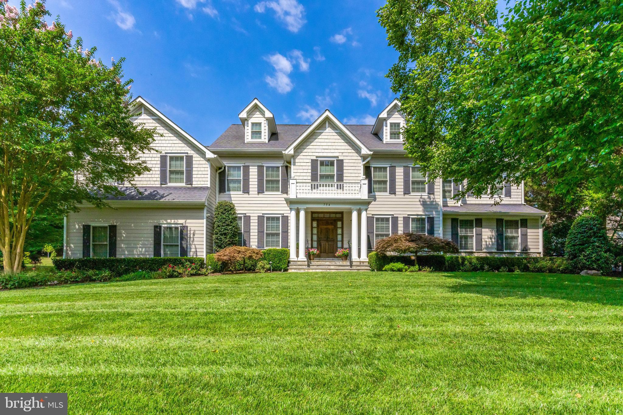 Nestled on a serene, tree-lined street near Great Falls Village, this stunning residence epitomizes luxurious living with expansive outdoor entertaining space. The main level features a seamless blend of formal and informal areas, highlighted by a chef’s kitchen complete with an oversized island perfect for gatherings and casual dining. Dine al fresco by stepping outside to the heated veranda equipped with a stone fireplace and an outdoor kitchen, all set within a beautifully landscaped yard, ideal for year-round outdoor living and entertainment. The upper level offers a spacious owner's suite boasting two large walk-in closets and a spa-like bathroom, three additional bedrooms, and two and a half bathrooms. A versatile fourth level serves as a potential bedroom, second office, or hangout space. Additional features include a finished lower level with a media room, exercise room, and an additional bedroom, providing ample space for relaxation and recreation. The property also includes a three-car garage, ensuring plenty of storage and parking. Don’t miss the opportunity to make this exquisite property your own