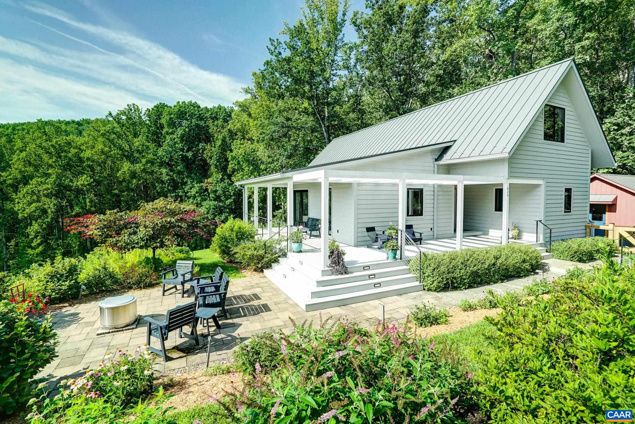 One of a kind custom contemporary farmhouse by builder Peter Johnson on 22 acres in Bundoran Farm. Set within 2,300 acres of permanently protected land in North Garden. One of Central Virginia's premier conservation communities offers direct access to 15 miles of maintained trails, community lakes, working farmland, orchards, and Pippin Hill Vineyard. This home affords sweeping valley and Blue Ridge views from the great room, owner's suite, pergola deck & fire pit patio. The soaring great room features exposed wood trusses with steel connectors and a floor-to-ceiling linear gas fireplace. The contemporary kitchen includes a large island, quartz counters, professional gas range, custom maple cabinets, and porcelain backsplash. The main-level primary suite with an ensuite bath offers a freestanding soaking tub, quartzite vanity, and curbless steam shower. Two upstairs bedrooms share a full bathroom. Detached finished studio by Geo Barns is ideal as a home office or creative space. Native, drought-resistant perennial gardens, a screened porch, and a wrap-around covered/pergola deck for outdoor entertaining. Relax in the peaceful Zen garden with bubbling waterfall. Unfinished walkout lower level with HVAC plumbed for full bath.,Painted Cabinets,Quartz Counter,Fireplace in Great Room
