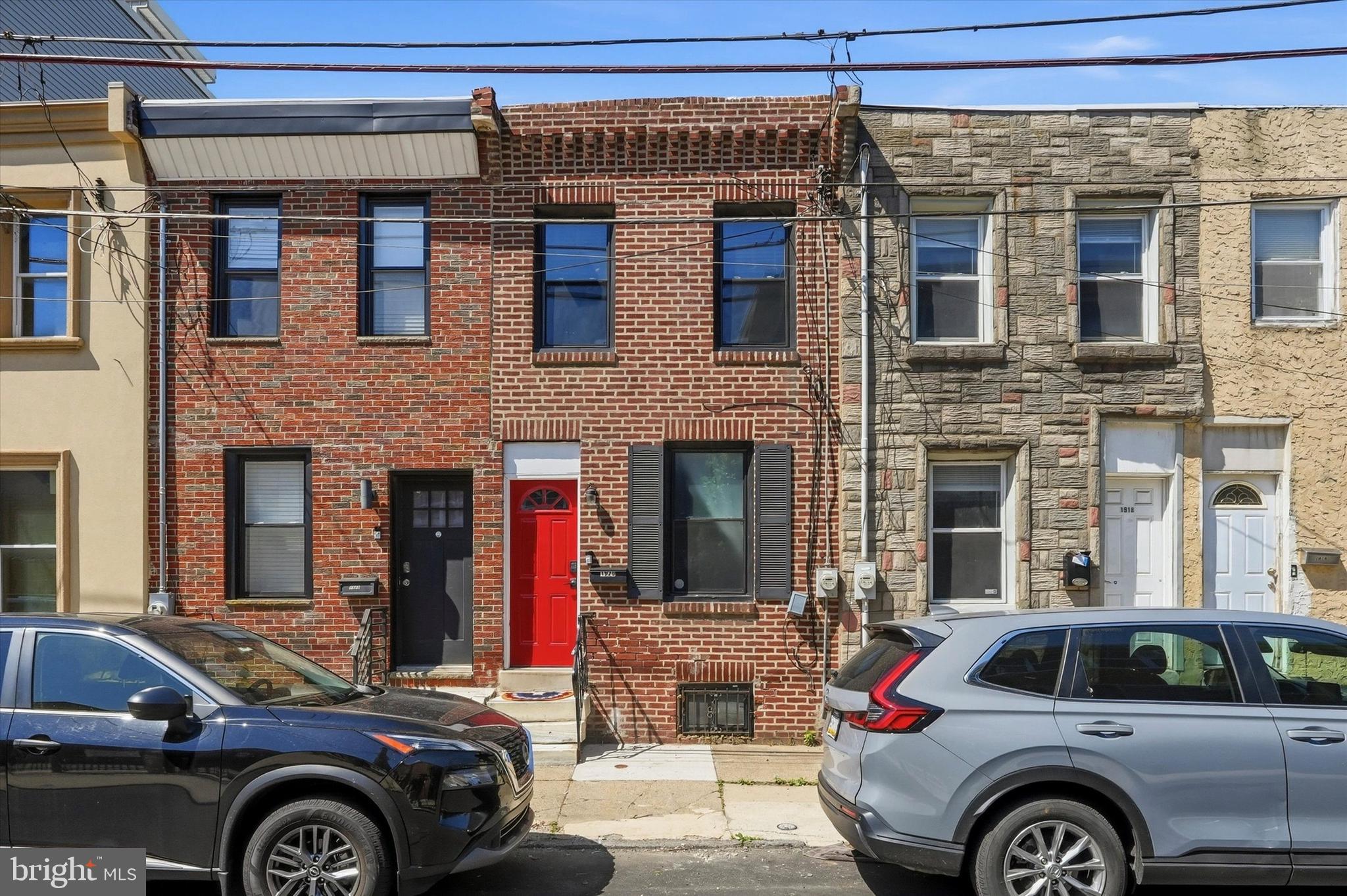 Charming townhome at 1920 E. Firth Street in East Kensington, blending original character with modern updates. The bright main level features an open living and dining area with restored hardwood floors, tall ceilings, and large windows that flood the space with natural light. The updated kitchen offers quartz countertops, stainless-steel appliances, ample cabinetry, and a cozy breakfast area perfect for everyday living. Upstairs, two generously sized bedrooms include a primary retreat with walk-in closet space and period details, while the full renovated bathroom showcases contemporary fixtures and a clean, spa-like finish. The finished lower level provides flexible space for a home office, family room, or gym, plus convenient in-unit laundry and additional storage. Outside, a private fenced rear patio creates a peaceful spot for entertaining or relaxing. Located on a tree-lined block with easy access to local shops, restaurants, transit options, and neighborhood parks, this well-maintained home offers a move-in-ready combination of historic charm and modern convenience.