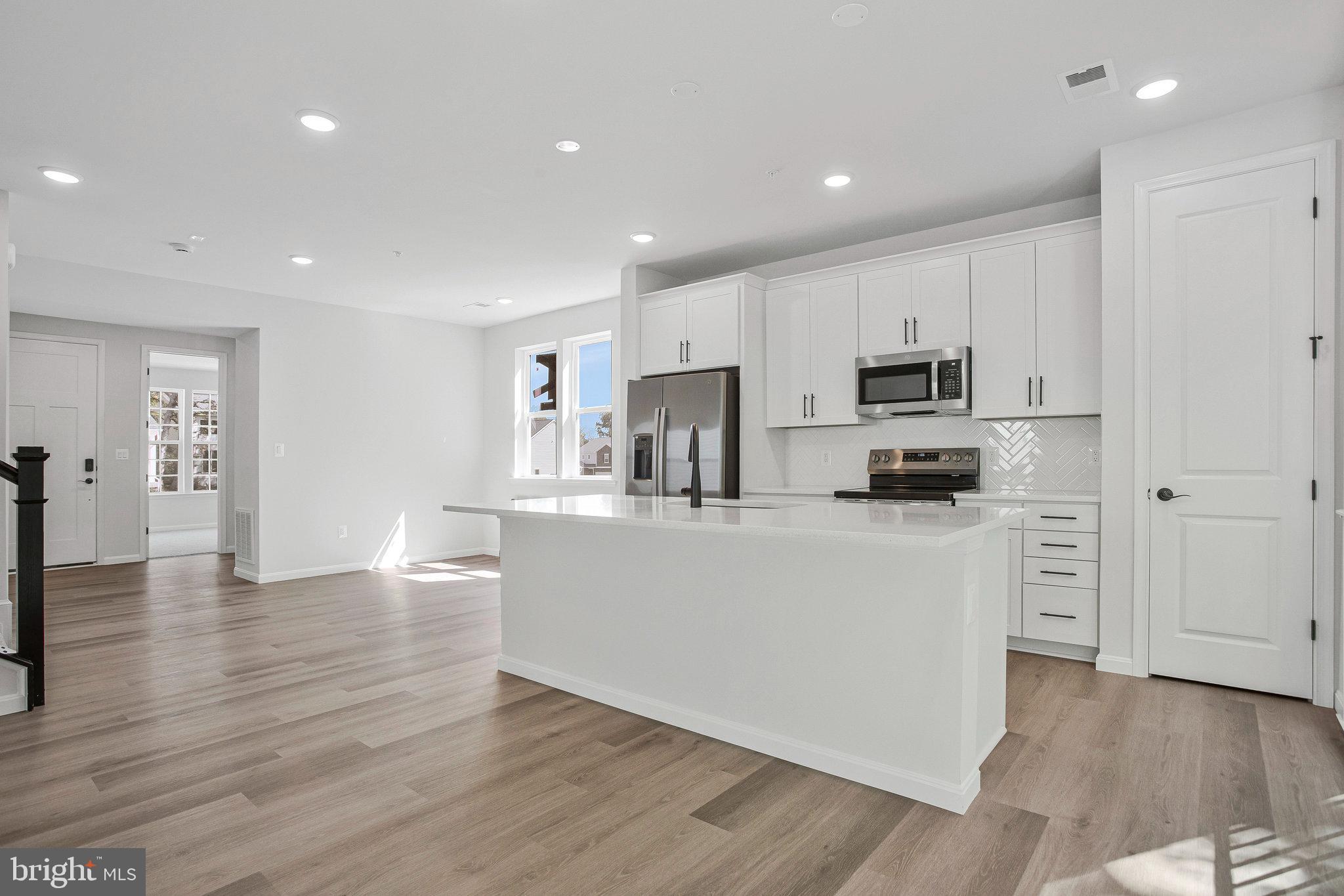 THIS NEW HOME WAS BUILT WITH A MAIN LEVEL BEDROOM AND FULL BATH!  READY FOR IMMEDIATE OCCUPANCY!  The Pearl plan offers two stories of thoughtful living space. A spacious kitchen provides a panoramic view of the main floor—overlooking an elegant dining room and a large great room.  Upstairs, a primary suite offers a roomy walk-in closet and attached bath. You will love the 2nd floor Loft area in additional two 2 large bedrooms. Includes beautiful white cabinets with Matte Black hardware, upgraded carpet, Luxury Vinyl Floors and ceramic tile, plus upgraded faucets, 9' ceilings, and 8' doors .  Model is OPEN but visitors are encouraged to call ahead to be guaranteed a dedicated appointment and to verify open hours.  WOODED LOT!
