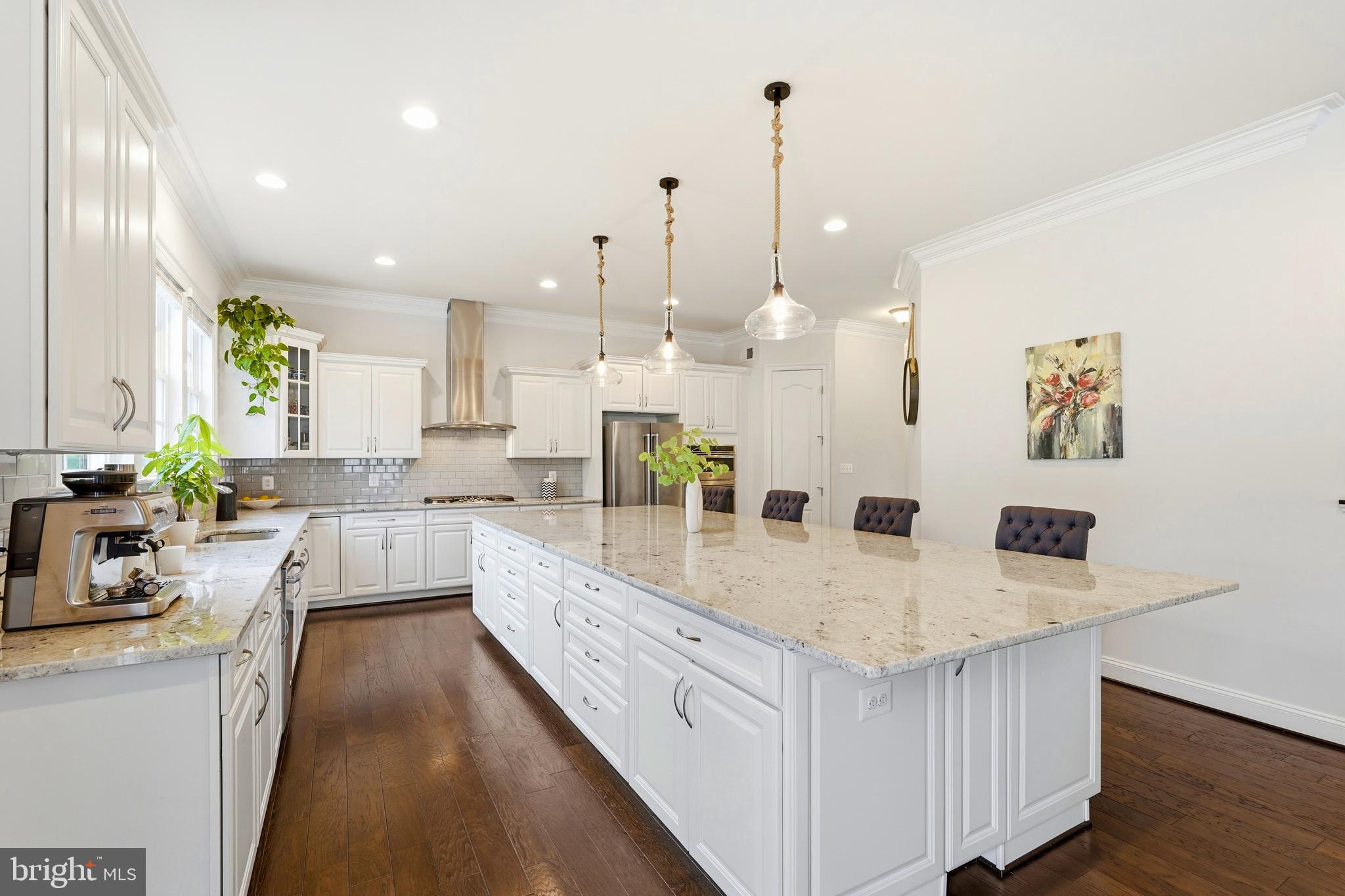 OFFER DEADLINE: SUN, 6/14, 9PM | Don't miss this rarely available Everhardt II floor plan located at much sought after Willowsford’s GRANGE VILLAGE - the ONE of FOUR distinct interconnected VILLAGES. Perfectly positioned on a premium homesite, nestled against thick WOODED backdrop, featuring highly desirable WALK-OUT, & convenient SIDE-LOAD garage. Charming STONE facade & covered front PORTICO creates striking first impression; massive home of 6,294 sqft living across 3 finished levels featuring 6 large bed rms, 5 full baths, & a half bath. SPRINKLER system in place for lush green lawn.<br><br>Discover unparalleled lasting VALUE & impeccable CARE of this precious home! Fresh paint, accent walls, OAK STAIRCASE to upper, rich HARDWOOD floors all thru main (except for main bed rm), LVP at lower, soaring 10-FOOT ceiling paired w/8-FOOT doors at main, gracious 9-FOOT ceiling at upper & lower, architectural details, crisp TRIMS at formal dining, TRAY ceiling at primary, cased openings, extensive hallways, blend of mid-century & modern light fixtures, ample recessed, & surface mounts enhances the home's overall aesthetic. To add, are custom blinds, ceiling fans, & strategically placed media points.<br><br>Celebrate a perfect blend of FORMAL ELEGANCE & CASUAL COMFORT of this incredible home! The foyer seamlessly transitions into the living & dining spaces w/stately COLUMNS creating an artistic boundary on either side. Exceptionally expansive family serves a true retreat! Accentuated by an oversized REAR BAY w/stretch of windows, alongside complimented w/additional SIDE windows, the area floods w/abundant natural sunlight. The FIREPLACE w/mantle at center creates alcoves to its either sides for your favorite art/decor display. Kitchen is a show stopper! Gigantic CHEF's GOURMET kitchen anchored by a humongous CENTER ISLAND; generous workspace/spot for homework/space for meals/gathering area for entertaining guests. Crisp white cabinetry w/subway backsplash provides a clean perimeter w/a line of windows over the undermount sink. Granite counters, upscale SS Appliances, & pendent lights complete the look. Pantry tucked to the corner. Enjoy ultimate convenience of the main-level bed rm w/a full bath & an enormous walk-in closet; ideally suited as a guest retreat/in-law suite. This versatile space can adapts to a home office/library/study as well; furnishing endless possibilities-cater the rm to your family needs.<br><br>Upper level opens to a luxurious primary suite boasting dual walk-in closets & deluxe spa-like bath w/separate vanities, a large walk-in shower, corner soaking tub, & private water closet. At the opposite end of the hallway is a bright guest suite that includes its own attached bath & huge walk-in-closet. Two additional bedrooms share a well-appointed Jack-and-Jill bath w/plenty closet spaces. To continue, a convenient hall linen closet.<br><br>Lower level is an entertainer's nook! Vast rec area, cozy exercise rm, perimeter wet bar, & immense bed rm w/closet & dual entry spa bath. Wait to immerse & experience premium HOME THEATRE set up! BenQ HT3550 4K UHD projector delivering stunning cinematic visuals w/HDR support. The audio system is powered by a Sony AV Receiver/Amplifier, driving Klipsch floor-standing speakers w/Dolby Atmos elevation drivers complemented by Polk Audio satellite speakers producing a three-dimensional audio environment.<br><br>Willowsford, a master planned community that flavors rural & urban living simultaneously; fresh farm-to-table produce, expansive open spaces, & top-tier upscale amenities providing a healthy active lifestyle. Two clubhouses w/resort-style pools, walking paths, scenic trails, lakes, rolling landscapes, play areas, community gardens, tree house, dog park, campsites, picnic areas, sledding hills, athletic fields, kids’ BMX bike track, & disc golf course. Embrace a lifestyle where everyday feels like an escape.<br><br>ReSale Conservation Fee: 0.25% of Gross Selling Price.