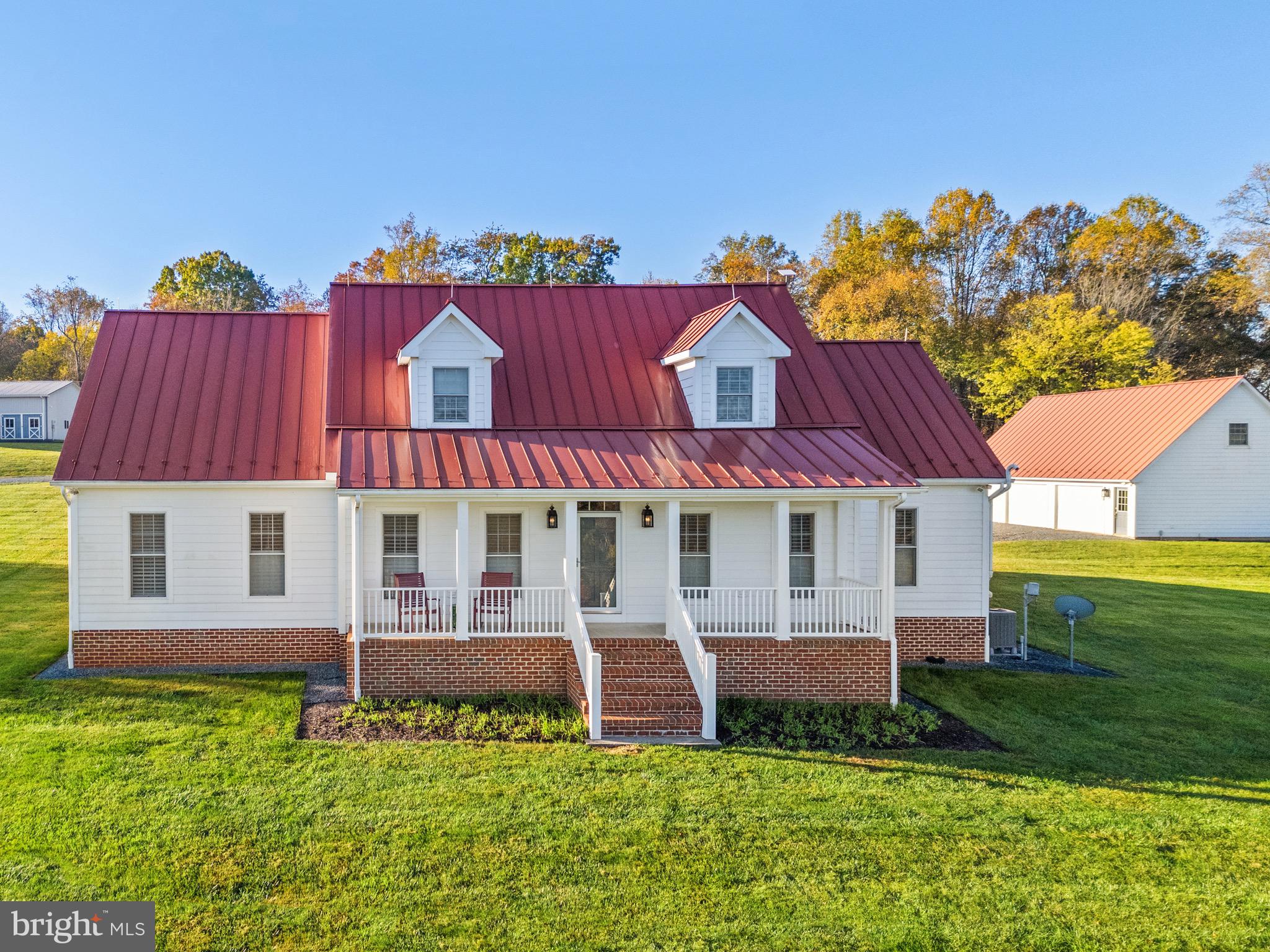 At Little Georgetown Farm, you can own a piece of Virginia’s rich history and natural beauty. This 141+/-acre estate designated a “Virginia Treasure” by the Commonwealth of Va, features sectors of the historic battlegrounds of Thoroughfare Gap, miles of private hiking trails, a picturesque orchard, breathtaking woodlands and fenced pastures, a 2.5 acre fully stocked pond, abundant wildlife and more—all nestled against the backdrop of your own slice of Biscuit Mountain.
The automatic gated entrance opens to a winding drive that crosses a quaint bridge over the babbling Trapp Branch, past a beautiful fountain on one of the property’s three ponds and leads up to the main house. Once there, you’ll be awed by one of Virginia’s most breathtaking views. 
The main home perfectly embodies the property’s natural beauty and historical charm. With 360-degree views of the estate, every corner of the house showcases the stunning landscape. This newly re-finished three-bedroom, two and one-half bath main house features a first-floor primary suite, elegant red oak floors, fireplace, plantation shutters, and modern appliances. The second level bedrooms with shared bath include private sitting rooms, each offering unique perspectives of the property. Relax in a rocker and enjoy the views on the covered front porch or the back patio. This charming home mixes country and contemporary styles for gracious living. 
Step through the tranquil sun porch to access the spacious in-law suite, featuring excellent natural lighting, plantation shutters, and ample space to comfortably accommodate guests. The suite includes a spacious living area and full bath on the main level and a cozy upstairs bedroom, offering both privacy and convenience to the main house. 
The detached 3 car garage provides plenty of room to accommodate all your on and off-road vehicles and the upstairs loft delivers convenient additional storage.
Located just steps from the main home is the party barn with attached greenhouse and garden shed.  This magnificent structure features expansive entertainment space on 2 levels, a full bath, laundry room, hobby room, and 3 bonus rooms.  The ventilated greenhouse features water permeable pavers and the shed is enhanced with a Gladiator Storage System and automatic doors.  Just imagine gathering fresh eggs from the delightful matching chicken coop just steps away.
Located at the highest point of the property, the guest house offers two bedrooms, two bathrooms, family room with fireplace, full kitchen, and stunning views of the entire property. Guests can take in the picturesque landscape from the covered front porch or take a short stroll to the 4-stall horse shed.  This shed offers endless options for storage or equestrian pursuits with automatic water troughs, electricity, and fenced paddocks.
Attached to the guest house is the 5-bay tractor barn with commercial grade automatic garage doors and an expansive storage loft.  This barn provides all the space needed for farm and recreational vehicles, equipment, storage, and workspace.
Located just minutes west of all the essential conveniences of Haymarket and Gainesville with easy access to Route 66 and just minutes southeast of the charming, historic towns of the Plains and Middleburg, with their private horse ride-outs, restaurants, vineyards, boutique shops, and art galleries, churches, and schools, Little Georgetown Farm is a one-of-a-kind country retreat in the heart of Northern Virginia.