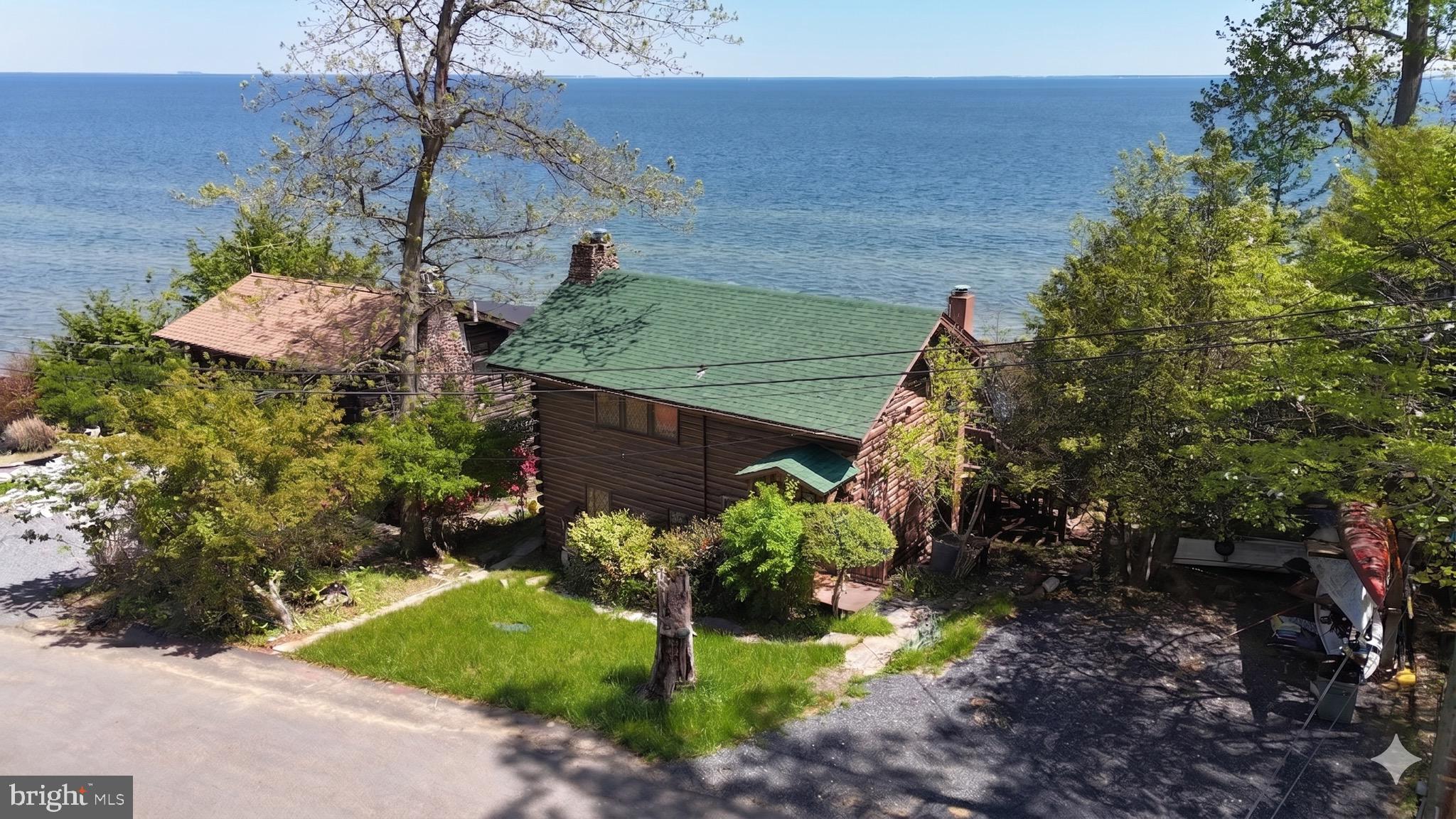 Far Niente: A Chesapeake Bay Retreat Unlike Any Other
There are homes, and then there are places that tell a story.
Tucked into the coveted waterfront community of Scientists' Cliffs, this extraordinary Chesapeake Bay cabin is more than a residence. It is a work of art, a conversation piece, a private museum, and a sanctuary for those who appreciate creativity, nature, and the simple joy of slowing down.
From the moment you step inside, you realize this is not a home that was merely built. It was lovingly crafted. A former owner, an accomplished artist and woodcarver, transformed the space into a living canvas. Every room reveals another chapter. Intricately carved woodwork. Hand-painted ceilings. Murals and carvings that invite curiosity and reflection. Cabinetry has been masterfully carved to resemble a library of books, blurring the line between function and imagination.
Threaded throughout the home is a single philosophy: **Far Niente**.
The phrase appears again and again, a nod to the Italian expression *Il Dolce Far Niente*, "the sweetness of doing nothing." It reflects a way of life that feels increasingly rare. A life centered around gathering, creating, sharing meals, and appreciating the beauty that surrounds us.
An old Italian proverb captures the spirit perfectly:
*"To make a good meal, you need a fisherman, a gardener, a cook, and a master to bring it all together."*
You can almost imagine those characters living here. Returning from the Bay with fresh rockfish. Picking herbs from the garden. Sharing wine and stories long after sunset. The walls themselves seem to celebrate those moments.
And then there is the view.
Climb to the rooftop deck and the world opens around you. Watch the Chesapeake Bay shimmer beneath changing skies. Feel the breeze coming off the water. Spot the neighborhood bald eagle soaring at eye level, gliding effortlessly below the cloud line as if putting on a private show just for you. Morning coffee becomes a ritual. Sunset becomes an event.
Outside your door, Scientists' Cliffs offers a lifestyle that feels worlds away from the everyday rush. This unique private community, nestled among the towering cliffs of Port Republic, is one of Southern Maryland's best-kept secrets. Residents enjoy two miles of private Chesapeake Bay beach, a boat ramp, swimming pool, tennis courts, basketball courts, community gardens, hiking trails, and a vibrant calendar of neighborhood events.
More than 20 miles of trails wind through protected forests managed by the American Chestnut Land Trust. Kayaks and paddleboards wait along the shoreline. Children spend summers exploring the beach and woods. Neighbors gather at the Community Center and share a deep appreciation for the area's natural beauty.
Scientists' Cliffs is not simply a neighborhood. It is a community of artists, scientists, nature lovers, and dreamers who understand that life is measured by experiences, not square footage.
If you've been searching for a waterfront escape that is truly one of a kind, a place where art and nature coexist, where every carving tells a story, and where the Chesapeake Bay becomes part of your daily life, this may be the home you've been waiting to find.
This is **Far Niente**.
This is the sweetness of doing nothing at all. Yet somehow, experiencing everything.