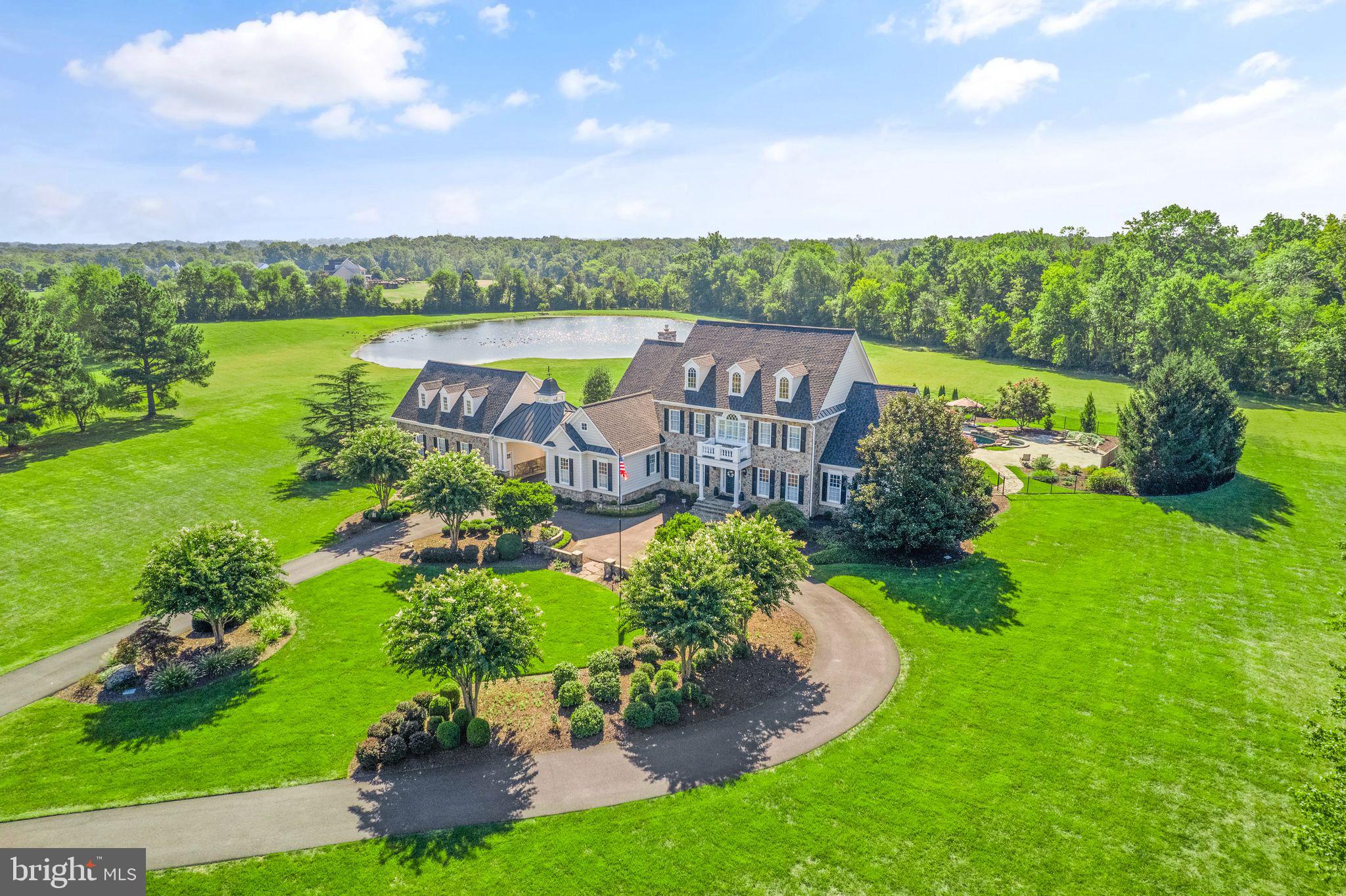 Stunning Custom built Estate Home in sought after Evergreen Farms community.  Almost 10,000 sqft of living space, 11+ Acres with your own private Pond and custom heated salt water Pool. Voluntary HOA. Every attention to detail has been made. Gleaming Hardwood Floors throughout the main level. Open Floor Plan. Step into the Grand 2 story Foyer. Formal Dining room with Crown Moldings, Chair Rail, Tray Ceiling, Ceiling Medallion and Stately Columns. Double height, light filled Living room with Crown Moldings, Columns, and Arched entryway to the light filled Solarium with Walkout to the Stone Patio overlooking the custom Salt Water Pool. Gourmet Kitchen with center Island great for entertaining. Breakfast area, Butlers Pantry, and Expansive walk in Pantry.  Family room is located off the Kitchen with Coffered Ceiling, Custom Mantel and Stone Fireplace. Main level Owner’s Suite with Tray Ceiling, Large Picture Windows to enjoy the views with Dual Powered Shades and Sitting Area with walk out to rear Patio. Custom Walk in Closet with organizers and center Island. Luxury Owner’s Bath with Jetted Tub, Frameless Shower and Dual Vanities. Main Level Study with Built-ins and Coffered ceiling, 2 Half Baths and Laundry area complete the Main Level. Upper level features 3 more light filled oversized Bedrooms, including a Jack - n - Jill Bath and Princess Suite.  Lower Level features an expansive Recreation Room, Wet Bar, Gym area, Bonus Room, 2 Storage areas and a Full bath.  Walk up to the stunning custom Salt Water Pool, Stone Patio and professional Landscaped Yard. Take the breezeway over to the Three Car Garage with Apt/Office/Bonus Room above with fifth Full Bath.  Plenty of acreage to enjoy with a Scenic View and Pond. Located on the 14th hole of Evergreen Golf Course.  Whole House Generator, New A/C 2019 with air scrubber and ultraviolet light system, New pool salt generator and pool Polaris 2022, New Roof 2020, New Hot Water Heaters 2020.   All this and so much more!