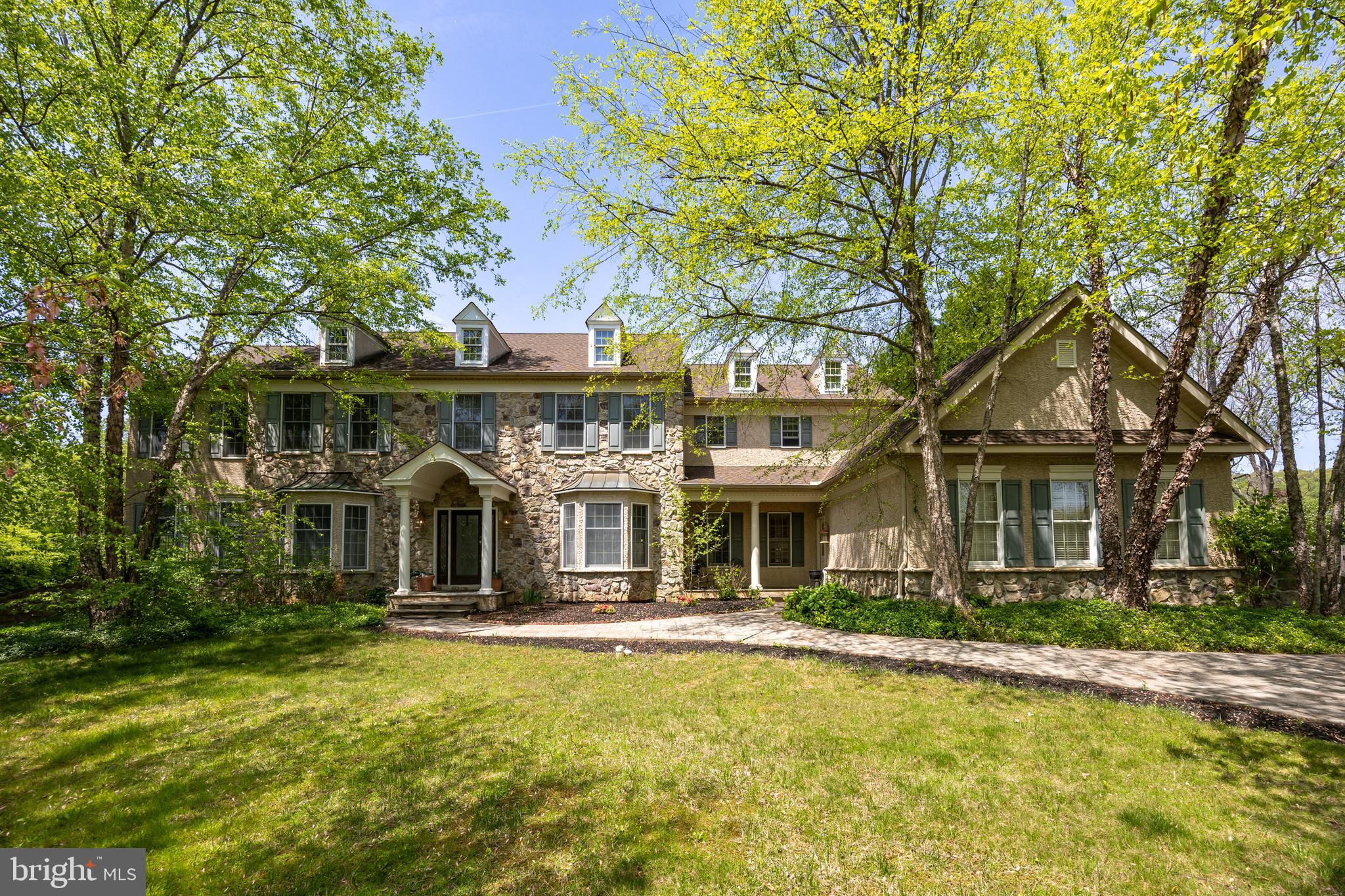 Nestled in the popular, walkable Swedesford Chase neighborhood of West Whiteland Twp., 301 Bell Court offers over 6,000 square feet of expansive living space. This exceptional residence boasts five spacious bedrooms—all located on the upper level—each with its own private en suite bathroom, providing privacy, comfort, and convenience for family and guests alike.
Soaring ceiling heights and abundant windows fill this home with natural light and the functional floor plan is ideal for both grand entertaining and everyday living. A formal dining room, private home office with adjoining library/study, and multiple living areas provide versatile space. The Kitchen features a gas cooktop, stainless refrigerator, beverage refrigerator, large pantry, and a center island with breakfast bar seating, plus an adjacent Sunroom and Breakfast Room – either space would work well for casual dining and sitting rooms.  On the far side of the Living Room is another huge Sunroom with windows on 3 elevations, fireplace, tiled floor, and French doors to a second rear deck. This room could be used as a main floor playroom, sitting area, game table area, or perhaps even for a golf simulator?  Elegant finishes, custom millwork, and thoughtful touches abound throughout the home. 
The fully finished daylight, walk-out lower level offers even more space for recreation and relaxation, featuring a large TV area, dining area, game table area, fitness room/bedroom, hobby room, and multiple storage rooms. A 7th full bathroom is also found on this level. Whether you're hosting a crowd or enjoying a quiet evening in, this home delivers the versatility and scale to accommodate it all.
Step outside and you’ll find an outdoor retreat just as impressive as the interior. The very private yard features a stunning in-ground pool and spa surrounded by a spacious patio. Adjacent to the pool, the pool house includes a convenient kitchenette and a half bathroom —perfect for summer gatherings. A covered outdoor fireplace area invites cozy evenings under the stars, while a dedicated playset or sports zone and expansive lawn offer ample space for recreation and gardening. 
Located on a tranquil cul-de-sac, 301 Bell Court combines privacy, community, and luxury in one of Exton’s premier neighborhoods. This home is a rare find—spacious, sophisticated, and ready to welcome its next chapter.