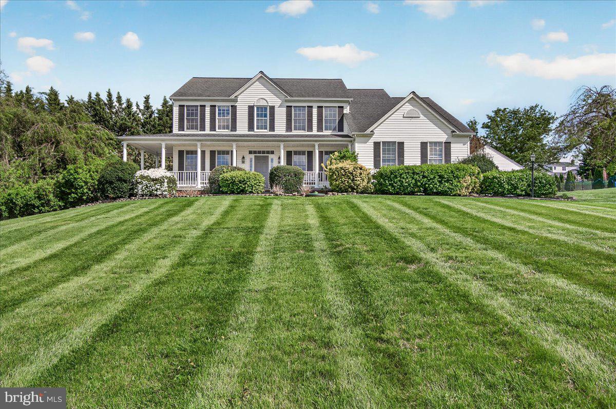 Nestled in the highly sought-after community of West Oak Fields, this custom-built 5,500+ Finished SF, original-owner Victorian Colonial sits on over an acre of beautifully maintained land and was crafted by Omenitsch Brothers. From the moment you arrive, you’ll be captivated by the expansive wraparound front porch—perfect for taking in breathtaking sunset views and the peaceful surroundings.
The property is truly one of a kind, featuring your own private orchard with blackberries, raspberries, blueberries, grapes, and mature trees that provide both beauty and privacy. Car enthusiasts and hobbyists will appreciate the oversized two-car side-load garage, along with a detached garage/workshop boasting soaring ceilings—ideal for projects, storage, or additional workspace.
Inside, the home showcases timeless elegance with hardwood floors, crown molding, and thoughtfully curated finishes throughout. The traditional floor plan offers both functionality and charm. A grand foyer welcomes you, with a sun-filled formal living room to the left and an elegant dining room to the right, complete with chair railing, crown molding, and a modern chandelier.
The spacious family room features a cozy gas fireplace, creating a warm and inviting gathering space. Nearby, a private study with built-in shelving and a stylish powder room add convenience and versatility.
The open-concept kitchen is designed for both everyday living and entertaining, featuring stainless steel appliances, freshly painted cabinetry, a center island, backsplash, and ample maple cabinetry. A bright breakfast area provides casual dining with easy access to the outdoors. Just off the kitchen, you’ll find a large walk-in pantry and a mudroom with access to both the garage and exterior.
Upstairs, a hardwood staircase leads to a generously sized upper level with hardwood flooring throughout the hallway. This level includes four spacious bedrooms, an upper-level laundry room, and a luxurious primary suite complete with a sitting area, walk-in closet, and en suite bath featuring dual vanities, a soaking tub, walk-in shower, and separate linen closet. A full hallway bathroom serves the additional bedrooms.
The fully finished walk-out lower level offers incredible flexibility and can function as an in-law suite or private apartment. It includes a fifth bedroom, a potential sixth bedroom or library, a full updated bathroom, and a large recreation area. The wet bar is fully equipped with a dishwasher, Sub-Zero refrigerator, stainless steel sink, granite countertops, and abundant cabinetry. Additional highlights include a hobby room with shelving, a stackable washer/dryer, and a third refrigerator for extra storage. Step outside to find a natural gas-powered Onan whole-house generator and easy access to the backyard retreat.
The outdoor space is equally impressive. The fenced backyard features black aluminum fencing, a concrete basketball court, a large storage shed with electricity and a garage door, and a stamped concrete patio ideal for entertaining. A tranquil fish pond with a waterfall adds a relaxing ambiance, while the expansive yard provides endless possibilities for recreation and enjoyment.
The large front yard enhances curb appeal, and the extended driveway offers ample parking. Located in West Oak Fields, this home provides a peaceful suburban setting with spacious lots, no HOA, and convenient access to parks, recreation, and major commuter routes including I-270 and I-70.
This exceptional property truly has it all—schedule your private tour today.