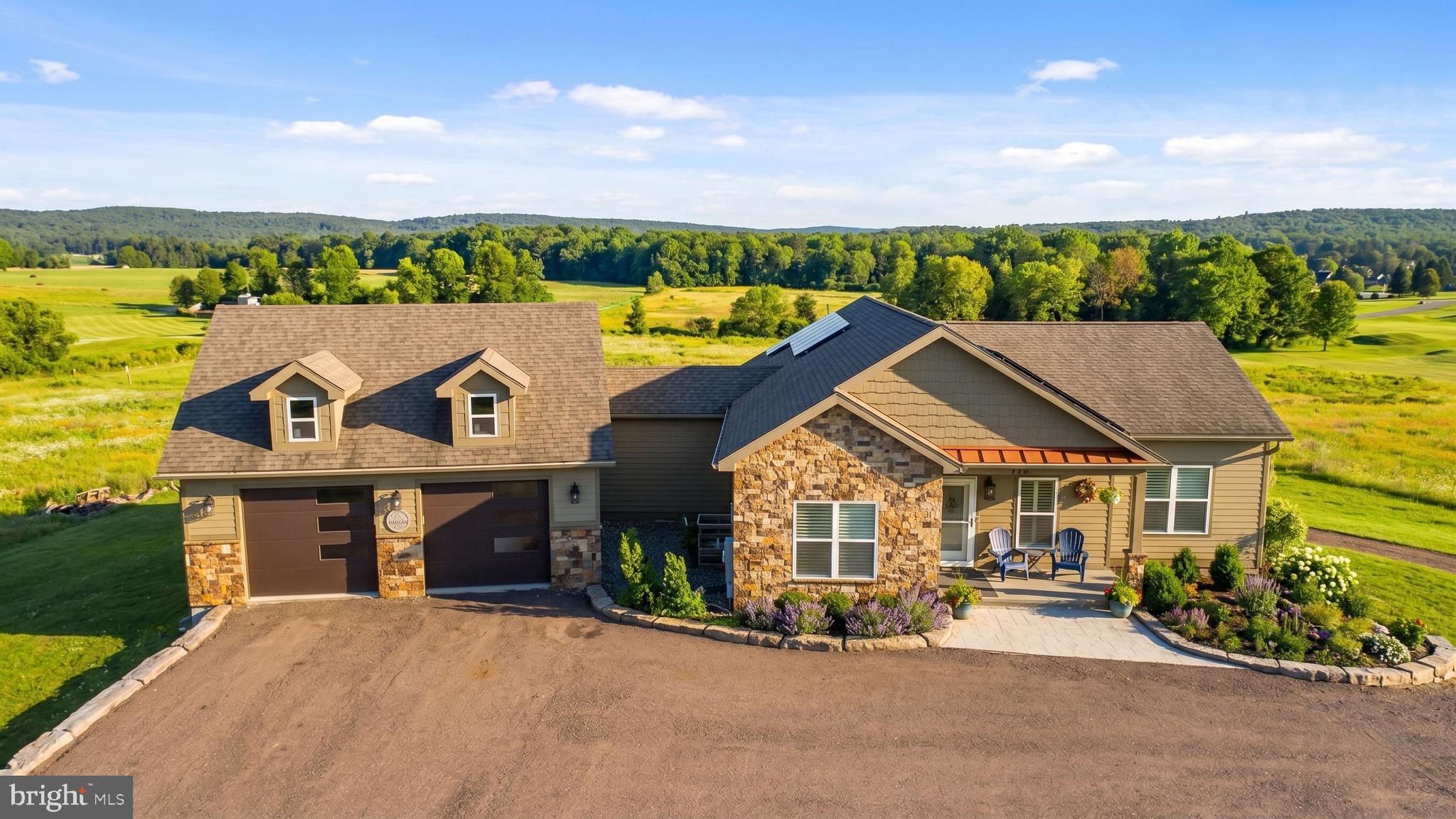 Stunning lake access contemporary with private dock slip in the sought-after Waterfront Greens community. Built in 2020 and thoughtfully designed for modern mountain living, this 6-ensuite bedroom, 7- bath home with ADA-compliant access offers expansive indoor and outdoor spaces, perfectly positioned to capture sweeping views of the par-3 golf course and Deep Creek Lake. Both levels offer kitchen and laundry for full living space on each floor. The main level features a gourmet kitchen with upscale finishes and premium stainless appliances, flowing seamlessly into an open living area anchored by a gas fireplace and expansive deck with retractable awnings. Multiple gathering spaces throughout the home provide flexibility for entertaining, including a fully equipped second kitchen on the lower level. Outdoor living is elevated with an enclosed 4-season area complete with a TV and vented grill space.  Relax in the hot tub pavilion or unwind around the fire pit while taking in the mountain air. A spacious 30x30 attached garage connects via a breezeway, offering abundant storage, while solar panels add efficiency and long-term savings. A newly established vacation rental, "Caddyshack" already has over $50,000 in rentals on the books for 2026! Situated on approximately one acre on the 7th fairway, this is your opportunity to own a spacious, newer construction, lake access home at one of Deep Creek Lake's most renowned lakefront communities. Call today for more details!