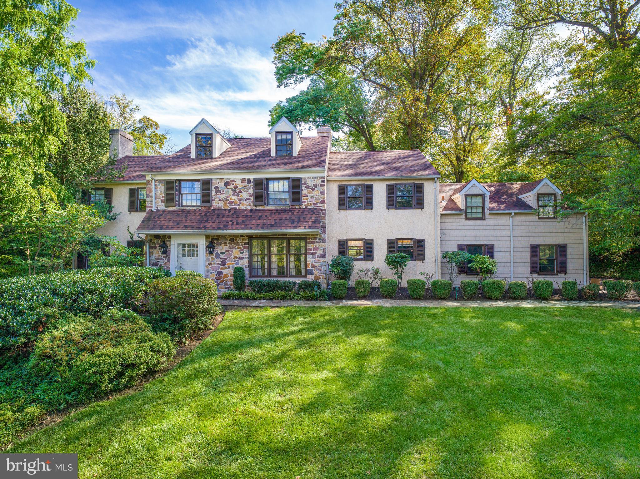 Open house Cancelled Saturday Nov 8 and Sunday Nov 9.. This beautiful custom-built stone Colonial was completed in 1972 by the original owner. It is being offered for sale for the first time. The home offers 4,425 square feet of living space on 1.13 acres. The expansive rear grounds provide lovely views and abundant space for outdoor recreation or relaxation. The setting on Valley Road is ideal—a quiet neighborhood formed by two cul-de-sacs that ensures privacy and minimal traffic.

Generously scaled rooms and architectural details throughout the home reflect a modern farmhouse sensibility—a timeless blend of comfort and craftsmanship.

Graceful proportions and soaring ceilings create a feeling of openness and light throughout. A large center hall foyer with half bath sets the tone for the home’s classic layout. The living room features a fireplace and large windows that fill the space with natural light. The private study includes custom built-in shelving, ideal for work or reading. The dining room, located just off the foyer, offers a welcoming setting for gatherings and everyday meals.

The kitchen and family room are joined by a double-sided stone fireplace, connecting the cooking and entertaining spaces. The kitchen includes an eat-in breakfast area, while the family room features beamed ceilings, doors leading to the patio and rear grounds.

A laundry and mudroom with exterior access provides additional functionality and connects directly to the two-car garage and access to the rear staircase for everyday convenience.

Upstairs, the primary suite features vaulted, beamed ceilings, a private balcony overlooking the rear grounds, and separate his and her bathrooms. Four additional bedrooms complete this level, served by two full hall baths; one includes its own half bath, ideal for guests.

The lower level offers a stone fireplace, flexible recreation space, and an unfinished area for mechanical equipment and storage.

This one-owner residence presents a rare opportunity to own a custom Main Line home distinguished by its privacy, scale, and enduring quality.