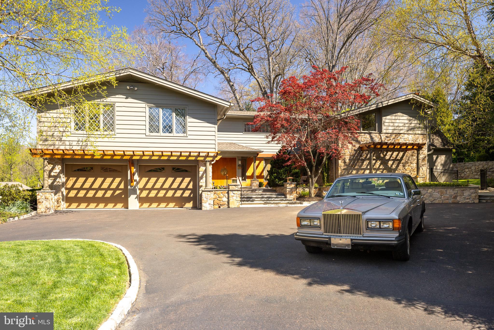 A once-in-a-lifetime opportunity to own this Mid-Century Modern Stone & Cedar home being sold by the original owner! Love of MCM homes designed by Neutra, Williams, Frey, Wexler & Cody led to the building of this remarkable home in 1963. Designed by architect Warren Beltz, Built by A. F. Mueller & Son, Landscape designed by J. Schlesinger, Interior designed by Irving Sharrow. Exotic woods, cabinetry, unique wall & floor finishes, no detail was spared. This home has it all; 5 bedrooms, 3 full baths, 2 half baths, 2 car garage, 3 fireplaces, an elevator, In-ground pool, dog run, multiple patios, deck & fitness center w/ spa in the sought-after Baederwood neighborhood in A rated Abington SD. The Belgian block-edged motor court & circular driveway wrap around a 70+ year-old Japanese Split-Leaf Maple. Stunning landscaping w/ boulders, specimen plants, flowers, trees, landscape & tree lighting & irrigation systems. Front & back courtyards w/ Fieldstone walls, Bluestone & Brick patios, walkways & steps. Privacy fencing & gates wrap side & back yards, patios & dog run & separately fenced & gated In-Ground heated pool w/ a private tree-lined yard perfect for entertaining, kids, pets, your next BBQ or pool party. Enter the grandeur of an MCM masterpiece of texture & light through the Foyer w/ 2 story windows, Brass Rail open staircase & stone walls overlooking the courtyard patio reached through the adjacent living room’s wall of sliding glass. The Living Room’s floor-to-ceiling stone fireplace & vaulted ceiling support multiple conversation areas for both intimate & large gatherings. Step down to the cozy Den w/ a fireplace, Walnut floors, Rosewood & Walnut cabinetry w/ a wet bar. The stately Dining Room has wood pocket & sliding glass doors to the courtyard area; a wall of Black Limba & Walnut cabinetry w/ stone accent walls lit by diffused lighting. The bright kitchen w/ a dining area & breakfast bar are wrapped by windows, abundant cabinetry, counter space, pantry closets, main & separate prep sinks, SS appliances, doors to the courtyard, patio & dog run. A family room w/ 2 story vaulted ceilings, windows, skylights, fireplace, door to patio & elevator. 1st FLR Laundry/Mudroom w/ a sink, storage, laundry chute, washer & dryer flank back stairs. The Primary Bedroom has elevator access, an ADA-compliant full bath, extensive custom closets, storage & separate dressing areas (1 w/ make-up counter & sink). Down the hall, past a walk-in cedar closet, is an Ensuite Bedroom w/ ample storage in the DBL closets, built-ins & large tiled bath. Off the 2nd floor foyer find 3 bedrooms, a full bath, linen closet & hidden-door storage. A finished lower level w/ a chairlift, 2nd Powder Room, mirrored fitness center w/ Sauna, Steam Shower & Whirlpool. Lots of space for a kids & pets playroom, home theater/office/business, workshop, storage or In-law/Nanny suite. A 2-car garage & covered front deck complete a truly special home w/ every surface & architectural feature curated & professionally installed. Thoughtful design, function & simplicity, rich finishes, spacious rooms & lots of windows that marry both the rooms & views provide an MCM home that is fresh & modern today. Original & period details have been preserved in an MCM time capsule w/ updated amenities & luxuries: an elevator, HE zoned gas heat, hot water, central air & air purification systems, Low-E Casement & Skylight windows, Pella sliding glass & entry doors, over 200 amp electric, whole house standby generator, architectural shingle roof w/ ridge vents, gutters w/ guards. Award-winning local schools & prestigious private schools. Walk to Whole Foods, Trader Joe's, Target, Starbucks, WaWa, Dunkin, CVS, PNC, Abington Hospital, Abington HS & MS, Highland ES, dining, shopping, parks, trails, lakes, golf, tennis & Pickleball. Easy access to all major traffic routes for easy commutes. Walk 2 blocks to the Noble SEPTA Train station to Philadelphia, 30th St. Station & Philadelphia Airport.
