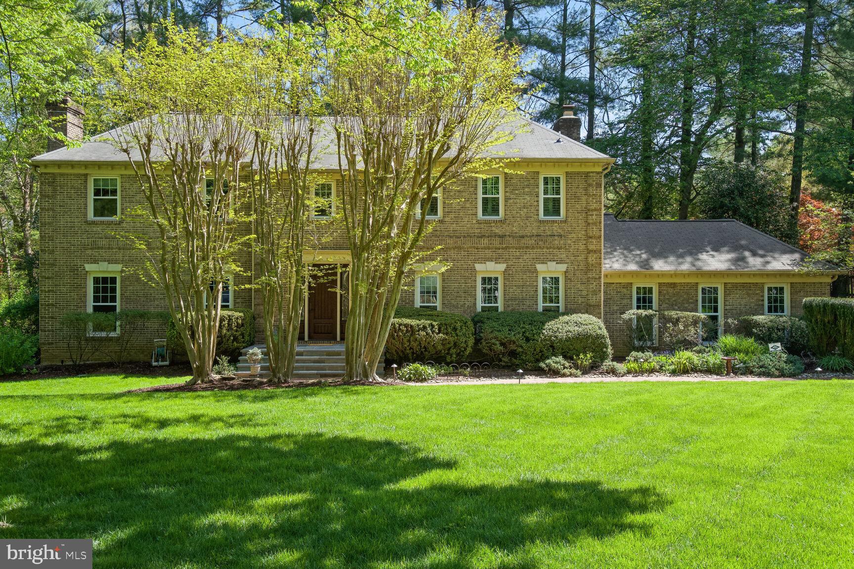 This original model home for  Mclean Country Estates is majestically sited on a cul de sac lot, set far back  from the street and framed by oak, cherry and maple trees in the front and tall white pines in the back! Beautifully landscaped  half acre lot with an expansive side yard that backs  to a  bonus common area,. The new brick walkway, landscape lighting and slate front porch complete the picture for stunning curb appeal.   This center hall colonial  home is 4 sides brick with a side load garage plus a new asphalt driveway! Beautifully upgraded with 4 renovated bathrooms. Tons of storage and closet space throughout.  Gleaming hardwood floors greet you in the  open foyer and extend through the main level.  Chef's kitchen is updated with farmhouse style white cabinetry, granite counters, and center island with a Jenn aire cooktop. Bosch dishwasher, stainless steel  double oven and refrigerator plus a wine fridge complete the kitchen which includes  plenty of space for a large table with serene views through the bay window of backyard pond and deck. Spacious family room with a floor to ceiling stone surround fireplace & hearth, walls of cherry built in cabinets, beamed ceiling  and a 6 speaker surround sound system - perfect for entertaining or for cozy evenings around the fireplace.  New screened doors off family room to the refinished deck and pond. First floor library with cherry built-ins offers relaxing views of front yard,  perfect for your home office. Living room with marble surround wood burning fireplace and a formal dining room complete the main level as well as a first floor laundry room off the garage. Bonus storage in the garage with pull down stairs. The upper level features hardwood throughout and a luxurious primary suite with newly renovated bathroom with dual vanities, walk in shower and freestanding tub plus shelving nearby. Plenty of closet space in the primary includes his & hers walk in closets with organizers. Bonus sitting room that could make  a perfect home office opens to the primary bedroom. Windows have plantation shutters. Bedroom 2 has a spacious wall closet and full en suite newly renovated bathroom. Two additional bedrooms upstairs with a  renovated hall bath. The lower level features yet another option for home office space or a workout room or den, next door to a full bath. Luxury vinyl plank flooring with walls of built ins and a huge storage room with shelving completes the lower level. The rear yard features a newly refinished deck with stone walkways from either side and a goldfish pond with water pump. Off to the side is plenty of green space backing to a common area that provides privacy and room to roam. Bird feeders abound, attracting dozens of different species of songbirds! Top ranking  school pyramid and easy access to Tysons, the Toll road and Beltway and close to downtown Great Falls.   All new triple pane, energy efficient, UV protective windows recently installed.  Inground water sprinkler system for easy yard maintenance. Whole house generator!