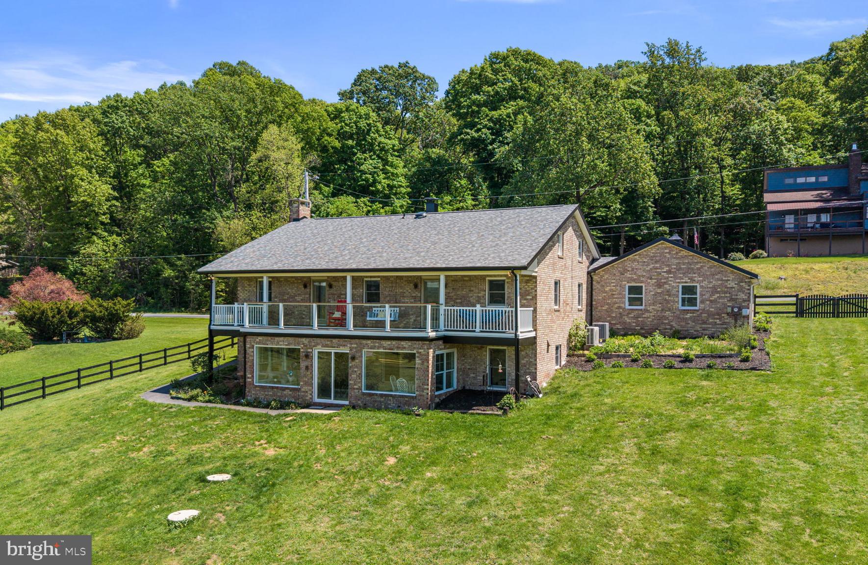 Mountain, Golf & Ski Living at Its Best in Fairfield!

Welcome to this beautifully updated 6-bedroom, 3.5-bath home on .77 acres, perfectly situated on the golf course at Ski Liberty and within walking distance to the slopes. Offering an ideal blend of year-round recreation, scenic beauty, and thoughtful renovations, this exceptional Fairfield property is ready to enjoy.
Designed with a unique and thoughtfully “flipped” floor plan, this home offers a layout that balances privacy with open, inviting gathering spaces. Entry into the home brings you to the bedroom level, providing separation and quiet retreat areas. Just below, the main living level unfolds with the kitchen, dining area, spacious living room with wood-burning fireplace and built-ins, and a beautifully renovated sunroom. This creates an ideal space for entertaining, relaxing, and taking in the scenic surroundings.
You’ll find generously sized living areas and six very spacious bedrooms, providing comfort and flexibility for family, guests, vacation living, or entertaining. The inviting living room features a cozy wood-burning fireplace, built-in bookshelves, and a built-in desk area, creating the perfect space to gather, relax, or work from home.

This home has been extensively updated for both style and peace of mind, including a new roof, new windows on the top floor and sunroom, new luxury vinyl plank flooring on the entry, stairs, and basement level, remodeled primary bath, remodeled hall bath, renovated sunroom, new hot water heater, new washer and dryer, new refrigerator, new well pump, whole-house water filtration system, and a new AC/heating unit for the basement level. A new fence further enhances the outdoor living experience.

Designed to maximize the stunning setting, a full-length deck stretches east to west across the entire back of the home, offering abundant space for entertaining, outdoor dining, or simply soaking in the spectacular golf course views and breathtaking sunsets over Jack’s Mountain.  Access the deck from the updated primary suite complete with soaking tub and walk in shower or the bedroom/office both located in the back of the home facing the golf course.

The beautifully renovated sunroom with ceramic tile flooring serves as a peaceful retreat for morning coffee or relaxing evenings while enjoying the surrounding scenery.

Opportunities like this rarely come along—an extensively updated 6-bedroom home on the golf course at Ski Liberty, with walkability to the slopes, breathtaking mountain sunsets, expansive outdoor living, and major system upgrades already completed. Whether for full-time living, a weekend escape, or an investment property, this is the kind of home buyers wait for and regret missing when it’s gone. Schedule your showing and experience everything this one-of-a-kind mountain retreat has to offer.