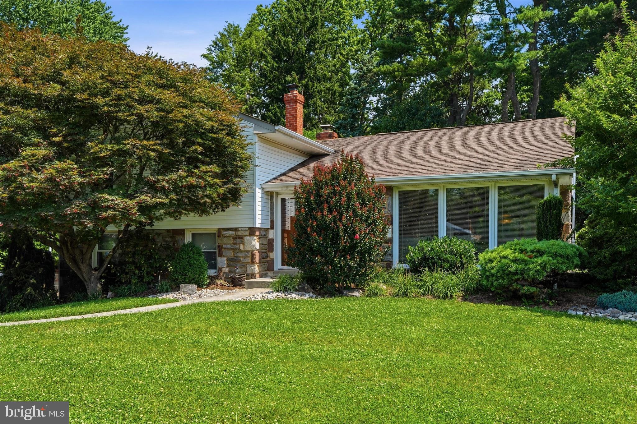 Welcome to 627 Meadow Road, Huntingdon Valley—a beautifully maintained Mid-Century stone split-level nestled on a picturesque lot in one of Abington Township's most desirable neighborhoods. Lovingly cared for and thoughtfully updated by its current owners over the past 30 years, this exceptional home offers timeless character, flexible living spaces, and wonderful indoor-outdoor amenities.  An added benefit of this home is the versatile lower level, featuring several separate living spaces that provide the perfect opportunity to create a comfortable in-law suite or private guest quarters.   Step into the gracious foyer and be welcomed by a light-filled living room featuring newer hardwood flooring and dramatic floor-to-ceiling windows that bathe the space in natural light. The open-concept living and dining rooms create an inviting setting for both everyday living and entertaining. Sliding glass doors from the dining room lead to a covered deck overlooking the expansive, fenced backyard and in-ground pool.
The beautifully updated kitchen is truly the heart of the home, featuring granite countertops, a stylish tile backsplash, newer stainless steel appliances, abundant cabinetry, and generous workspace for preparing meals and gathering with family and friends. The lower-level family room offers a warm and inviting retreat with a striking stone fireplace, convenient powder room, and direct access to the large  patio.   This level also includes a finished bonus room, currently used as a home office, along with the laundry room.  The unfinished sub basement provides outstanding storage and the opportunity to create additional finished living space to suit your needs.
Upstairs, the spacious primary suite features ample closet space and a private en-suite bath updated with a newer vanity and toilet. Two additional generously sized bedrooms offer excellent closet space and share a well-maintained hall bath with a tub, updated vanity, and newer toilet. The backyard is an entertainer's dream. Whether you're relaxing beneath the covered deck, hosting summer barbecues on the large  patio, or enjoying the potential of the in-ground pool, this private outdoor oasis provides the perfect setting for making lasting memories. The fully fenced yard offers plenty of space for recreation, pets, and gardening. Located on a quiet, tree-lined street in sought-after Abington Township,  Huntingdon Valley, this home offers the perfect balance of peaceful suburban living and everyday convenience. Residents enjoy easy access to shopping, dining, parks, major highways, regional rail service, and several leading hospitals. Families will also appreciate the highly regarded Abington School District. This is a rare opportunity to own a lovingly cared-for Mid-Century home with exceptional space, versatility, and an unbeatable location. Don't miss your chance to make 627 Meadow Road your next home.