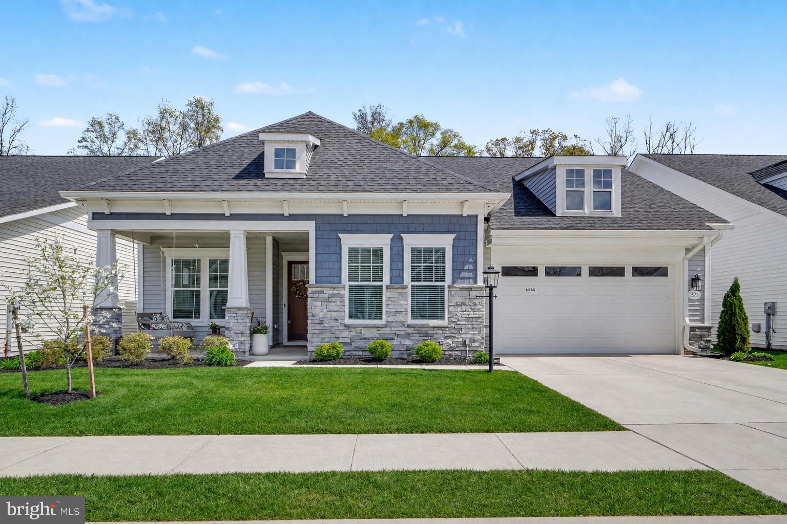 Welcome to The Quiet Creek House, a beautifully upgraded, move-in ready home in the heart of Amblebrook, a premier 55+ community designed for easy, resort-style living. Set on a premium lot backing to peaceful trees, this 2,400 square-foot home offers privacy, space, & thoughtful design throughout. From the charming front porch & timeless exterior with shaker siding, stone accents, & stately columns, to the soaring 10-foot ceilings inside, every detail feels warm & inviting.

Glass doors open to a private study that can easily serve as a third bedroom, while a guest bedroom & full bath are thoughtfully tucked away for comfort. The open-concept living area is anchored by a stunning kitchen with an oversized quartz island, KitchenAid gourmet appliances, & farmhouse sink. A butler’s pantry & spacious walk-in pantry provide exceptional storage, along with abundant cabinetry throughout. The subway tile backsplash extends all the way to the ceiling, adding a timeless designer touch. The kitchen flows seamlessly into a light-filled dining area, an open living room with a gas fireplace & custom built-ins, creating the perfect setting for both everyday living & entertaining.

The expanded primary suite is a true retreat. A custom trim accent wall adds character & warmth to the space. The ensuite bath features dual oversized vanities, a large tiled shower, & a private water closet. An impressive walk-in closet offers generous storage & connects directly to the laundry room, complete with built-ins, granite countertops, & a utility sink.

A heated four-season room extends your living space year-round. It features luxury vinyl plank flooring and stunning floor-to-ceiling windows that fill the space with natural light. Step outside to a fenced backyard featuring a beautifully hardscaped patio with a gas line ready for summer grilling. A full yard sprinkler system keeps the landscaping lush and low-maintenance.

 Additional highlights include an oversized two-car garage & a dedicated bulk storage room with built-in shelving for exceptional organization.

With indoor and outdoor resort-style pools, pickleball courts, a coffee shop, a state-of-the-art fitness center, and weekly social activities, life at Amblebrook truly feels like a vacation every day. Come experience the stunning details for yourself and schedule your private tour today.
