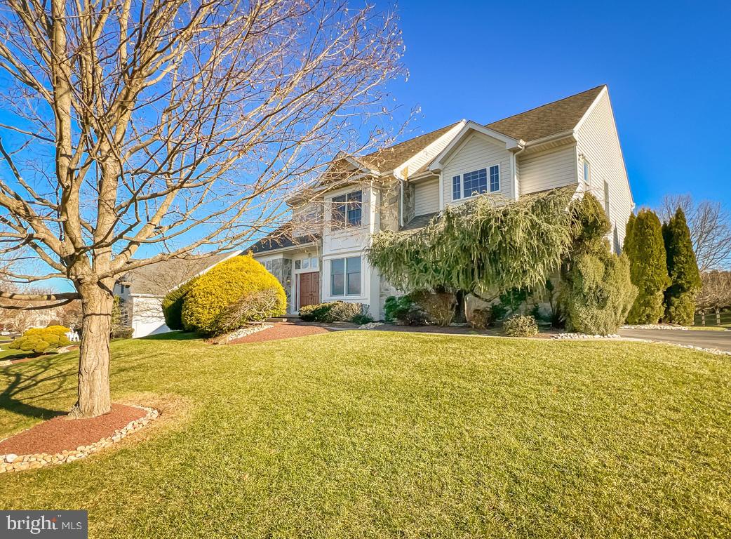 This is your opportunity to own a truly one-of-a-kind colonial in the award-winning Council Rock School District. This home has been lovingly maintained and the owners have made many smart and elegant upgrades throughout the years. The front landscaping is covered with pristine grass, mature trees, and lush shrubs. Adding to the curb appeal is the stone facade and the stained glass windows surrounding the front double Provia wood door with Therma glass, a charming touch. From the moment you enter this sprawling home, you will enjoy the custom details that make this home stand out - like the Brazillian teak hardwood floors that run through the first floor as well as the recessed lighting and upgraded blinds that are in most rooms. The Foyer welcomes you into the grandeur of the home with a modern chandelier, picture frame wainscoting, and a small sitting area close to the coat closet and the powder room, which is top-to-bottom newly upgraded. Your guests will gather and admire the vaulted ceilings and stained glass in the formal Living Room. Hosting is a breeze, with the formal Dining Room boasting crown molding, tall, bright windows, and extra space with a bump out window, connecting to the eat-in Kitchen through a built-in bar area, recently converted from a Butler's pantry. The eat-in Kitchen and Family Room are in an open-concept style, with one seamlessly flowing into the other to create a cozy yet chic atmosphere. The gas fireplace within the stone wall of the Family Room keeps you cozy through the cold months, and when the weather warms up, open the double doors onto the 5-year-old composite wood Patio for outside dining and relaxing. The Kitchen has plenty of amenities to compliment any chef: a wine fridge, hardwood maple cabinets, quartzite countertops, subway tile backsplash, KitchenAid appliances, a 5-year-old Bosch dishwasher, a stainless steel double sink, refrigerator and a double wall oven, and a smartly placed island. The pantry was built just two years ago and separates the Kitchen from the dedicated Laundry Room, which comes with an LG washer/dryer, a granite double sink, and access to both the Backyard and the attached Garage. The extra wide staircase with commercial-grade carpeting takes you up to the bedrooms and full bathrooms on the second floor. The Primary Bedroom is flooded with natural light that fills the room from Brazillian mesquite hardwood floors to the vaulted ceiling. The window seat that overlooks the front yard helps to craft a relaxing atmosphere and brings together this large room. The massive walk-in closet with built-in shelves and drawers spans almost the width of the entire room.  Private and newly updated Primary Bathroom . Off the bedroom is a  sitting room/ exercise room/dressing room or office to use as you like. Relax in the large soaking tub as you take in the look of the renovated Primary Bath, with upgraded tile, a granite double vanity, the continued vaulted ceilings from the Bedroom, and a stall shower separated by a door. The hallway that connects all four bedrooms has the continued picture frame wainscotting from the Foyer and is wider than the standard. The remaining three Bedrooms are all considerably sized, all with room for a queen-sized bed and a double closet. The first room to the left of the staircase has laminate flooring, and the other two bedrooms have the same Brazillian cherry hardwood floors. These three Bedrooms all share a Bathroom with new tile, a new double vanity with a marble center and two sinks, a tub shower, and a dedicated linen closet just outside. Downstairs to the partly-finished basement, you'll have more than enough space for storage and fun. Two bonus unfinished rooms are off the main room, and the main room has plenty of space for a home gym and more. Outside to the magnificent, fully-fenced pool area, you'll find more of the same beautiful landscaping  granting you extra privacy as you enjoy your in-ground pool.