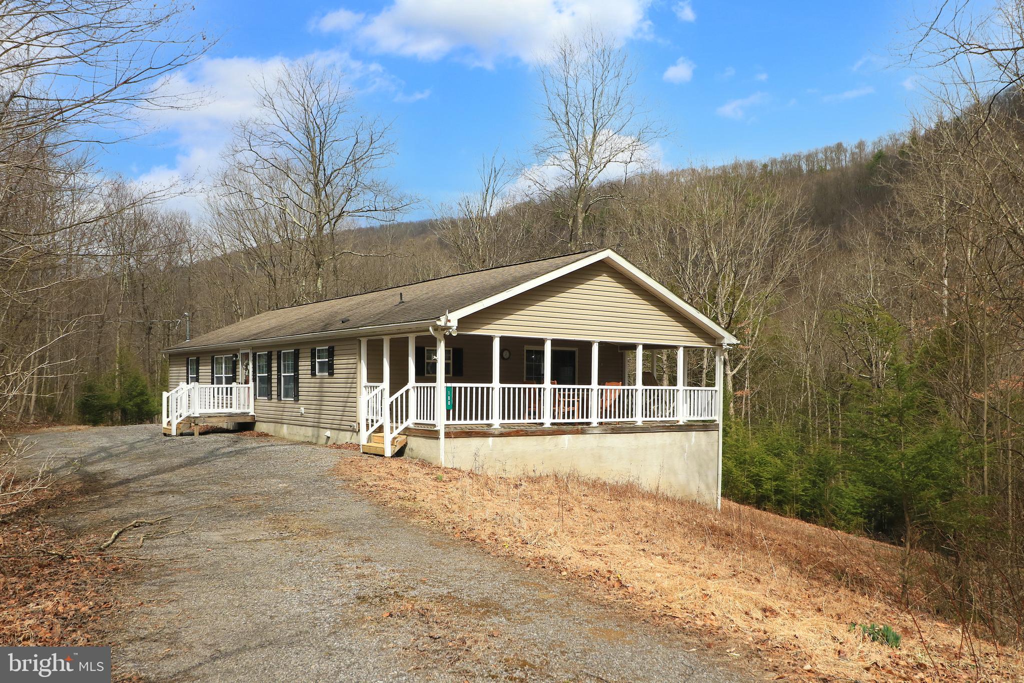 Nature Lover’s Paradise – Surrounded by Sproul State Forest.  Escape the hustle & bustle of everyday life & embrace the peace & tranquility of nature! Whether you're seeking full-time living or your own private retreat, this meticulously maintained, one-owner manufactured home is perfectly positioned on 10.21 serene wooded acres (enrolled in Clean & Green) & is encircled by the vast 305,450-acre Sproul State Forest. While the property doesn’t directly border the forest, it is all around, just a short distance away, providing effortless access to miles of trails, hunting, wildlife viewing, ATV riding & snowmobiling. The Southern Trailhead in Orviston, leading to the Bloody Skillet ATV Trail, is approximately 6.3 miles away.  For fishing enthusiasts, the Beech Creek stream, stocked yearly with trout, is just a stone’s throw away.  Step inside to discover a warm & inviting interior featuring vaulted ceilings & large windows that flood the space with natural light. The free-flowing floor plan is perfect for both everyday living & entertaining guests. Upon entry, you’re welcomed into a bright & airy living room, which seamlessly connects to the country-style eat-in kitchen, complete with included appliances, laminate flooring, solid wood cabinetry & ample countertop space for all your meal prep needs. A charming dining area & breakfast bar provide additional space to gather.  The kitchen flows into the comfortable family room, where a corner fireplace adds warmth & ambiance. Sliding glass doors lead to the covered porch, offering a seamless transition between indoor & outdoor living, the perfect spot to sip your morning coffee or enjoy an evening cocktail while soaking in the sights & sounds of the great outdoors.  The home features a relaxing owner’s suite with a nicely sized walk-in closet & a private full bath with a walk-in shower. 2 additional bedrooms both featuring walk-in closets & another full bath provides plenty of space for family or guests. A convenient first-floor laundry room with included washer & dryer ensures laundry day is a breeze.  The full, unfinished walk-out basement offers endless potential, whether you need storage or envision finishing the space for future living areas.  Outdoor Adventures at Your Doorstep.  In addition to the surrounding Sproul State Forest, this property is ideally located just 17 minutes from Foster Joseph Sayers Lake & Bald Eagle State Park, where you can enjoy boating, fishing, swimming, camping & picnicking. Plus, you're only 24 minutes from Lock Haven & 43 minutes from Penn State University, making it an ideal escape without being too far from modern conveniences.  If you’ve been dreaming of a nature-filled lifestyle with adventure at your doorstep, look no further—this serene retreat is calling your name!