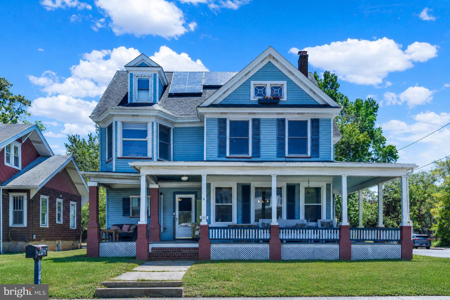 *THE HIGHLIGHTS: 4BR | 2.5BA | True primary suite | Bedroom-level laundry | Original hardwood floors | Pre-blight American Chestnut woodwork & details | Stained glass | Grand staircase | Updated kitchen with chestnut island | Walk-up attic with 2 finished flex rooms | Updated electrical | Newer main-level windows | Owned solar panels | Pellet stove conveys | Wraparound porch | Screened rear porch | Newly fenced yard | Detached 2-bay garage with upper storage | 30-amp RV hookup | Ample parking for RVs, boats & trailers. 

THE DETAILS: There are houses. And then there are homes that make you feel something the moment you walk in the door.  209 W Sunset Avenue is the second kind.  Built in 1910 and restored over the years, this 4-bedroom, 2.5-bath Victorian in Greensboro, Maryland is a true one-of-a-kind find, a property where original craftsmanship and modern practicality coexist in a way that simply doesn't happen by accident.  Step inside and the staircase sets the tone immediately. Original hardwood floors run throughout. Stained glass catches the light. Period lighting and intricate woodwork tell the story of an era when homes were built to last a lifetime. Many of those wood details, the doors, the trim, the island in the updated kitchen,  are believed to be pre-blight American Chestnut, a wood so rare today it's essentially irreplaceable. You cannot buy this. You can only find it.  And unlike so many Victorian-era homes that charm you on the surface but frustrate you in daily life, this one has been thoughtfully upgraded where it counts.  The primary suite is a true primary — private bath, double closet, real privacy. That's not a given in a home from 1910. Bedroom-level laundry means no hauling baskets up and down stairs. The kitchen has been updated with a chestnut island that ties the old and new together beautifully. Two finished rooms in the full walk-up attic give you the flexibility that most homes at any price point simply don't offer — a guest suite, a home office, an art studio, a gaming room, a yoga space. You decide.  The major-ticket items are already handled: the electrical system has been updated, the main-level windows and the roof  are newer, and the home includes owned solar panels. In Maryland — where electric bills can be genuinely painful — those panels are a financial advantage that pays you back month after month.  A pellet stove conveys with the home for extra comfort in the colder months.  Step outside and the property continues to impress. The wraparound porch is the kind you picture when you imagine slowing down. The screened rear porch overlooks a newly fenced backyard — private, quiet, yours. The detached 2-bay garage features a metal roof, floored upper-level storage, and an upper loading door that makes moving large items a breeze. A 30-amp RV hookup is already in place, and there is room — real room — for RVs, boats, trailers, and multiple vehicles.  This is a home with history, heart, and the infrastructure to live comfortably in it for decades. Homes like this come along once, if you're lucky.  Come see it before someone else does. (Garage being sold as-is.)