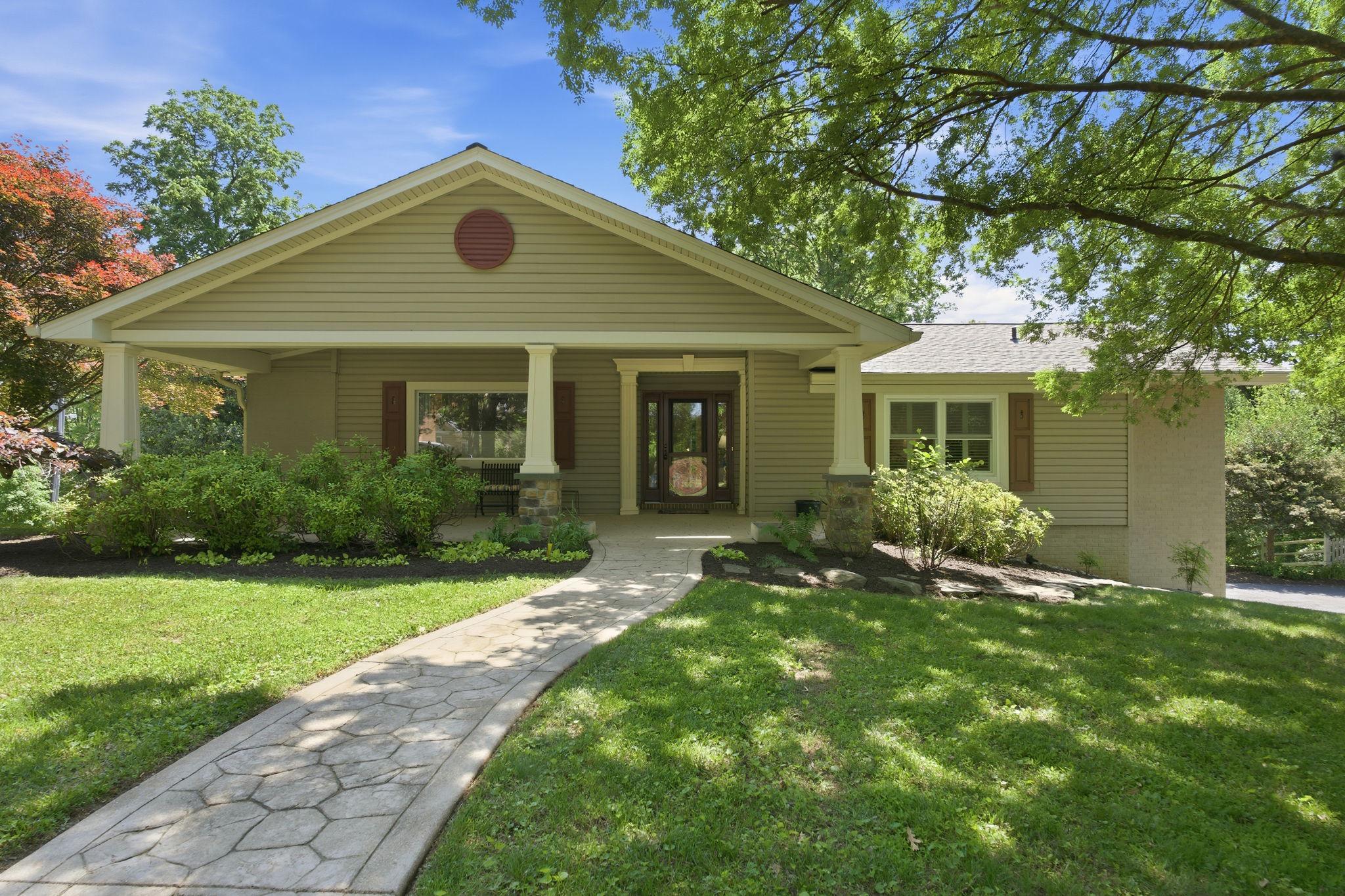 The elegant front entrance with its covered porch gives this house a 5-star curb appeal from the moment you arrive! You'll delight in this beautifully updated rancher, wonderfully expanded with a great room featuring walls of windows for natural light throughout the days. Built-in shelves flanking the fireplace in the gracious living room, a formal dining room, the charming family room (also with its gas fireplace!) open to the breakfast area and updated kitchen -- all  make this the home you've been seeking.  The primary bedroom has its own private bathroom, upated with a walk-in shower. The other two spacious bedrooms -- one of which has doors to the rear deck -- share an updated hall bathroom that includes the stacked washer-dryer. Wood floors stretch throughout the main level except for the kitchen and foyer. Downstairs, a second family room echoes the space of the main floor addition, with a door to the back yard. The lower level also has a room which would be perfect for a media room or exercise studio, plus a cedar closet, storage closets galore, and a half bath. There's also space for another laundry. The double garage, entered from the lower level of the house, is massive! The roof was replaced in 2026. Propane supplies the 5-burner gas range and the two fireplaces (living room fireplace currently disconnected).