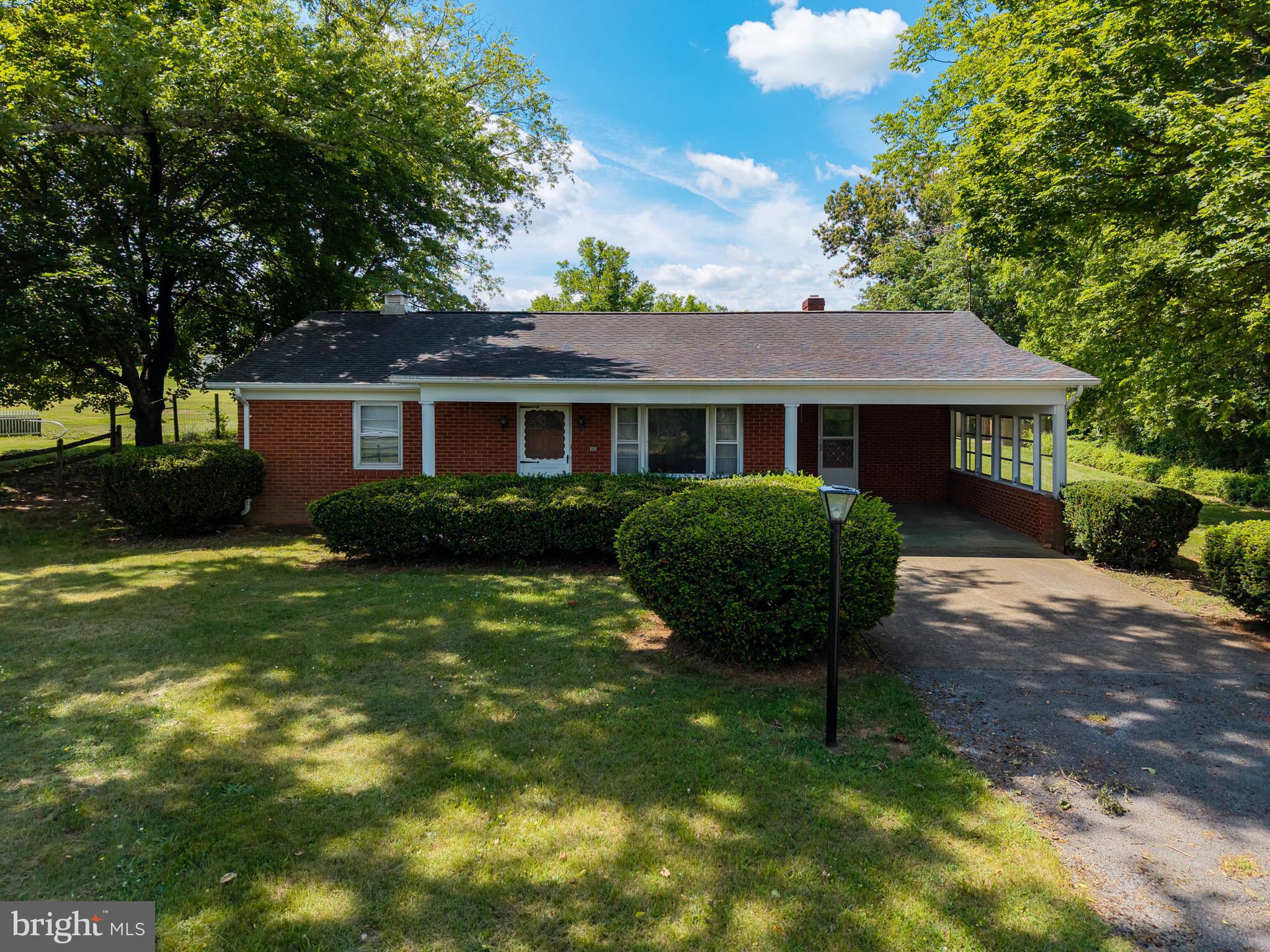 Charming brick ranch situated on a private 0.89-acre lot with a spacious backyard and plenty of room to enjoy the outdoors. This well-maintained home features 2 bedrooms, 1 full bath, a separate laundry room, and a functional kitchen complete with appliances.
Relax in the screened-in porch or take advantage of the attached carport for convenient covered parking. A detached garage provides additional storage and workspace options. The circular blacktop driveway offers easy access and ample parking.
Enjoy the peaceful setting while still having the comfort and convenience of single-level living. Whether you're looking for a starter home, downsizing, or seeking a quiet country retreat, this property has much to offer.