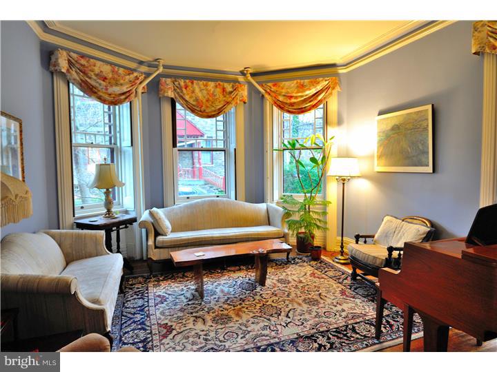This stunning three story stone  Victorian home can be your personal hideaway from the busy city after a long day. It boasts 6 bedrooms, 2.5 newly renovated baths, 2 car parking and is surrounded by a beautiful azalea garden. With 3 fireplaces,refinished hardwood floors, stained glass and Bay windows, a chandelier in the dining room, it is the perfect home for anyone that loves historical elegance. Additional amenities include a washer/dryer, an alarm system, ceiling fans in many rooms, 2 patios and a basketball court? yes a basketball court. Recently updated with thermal insulation, the energy efficient technology keeps the home extra cozy during the winter months. A good location for any runner, biker or outdoor enthusiast, your home would give you easy access to the city's green spaces which include but not limited to Wissahickon Valley and Fairmount Park districts. Via car it's a 15 minute drive to Center City and minutes to Main street Manayunk or Kelly Drive.  Also 2 min walk to the Tulpehocken train station if you commute. Close to La Salle University, Germantown Friends, Drexel Med and lovely Chestnut Hill Restaurants. You will be in the center of it all. Don't miss out on this great opportunity to have a grand romance with a beautiful home.