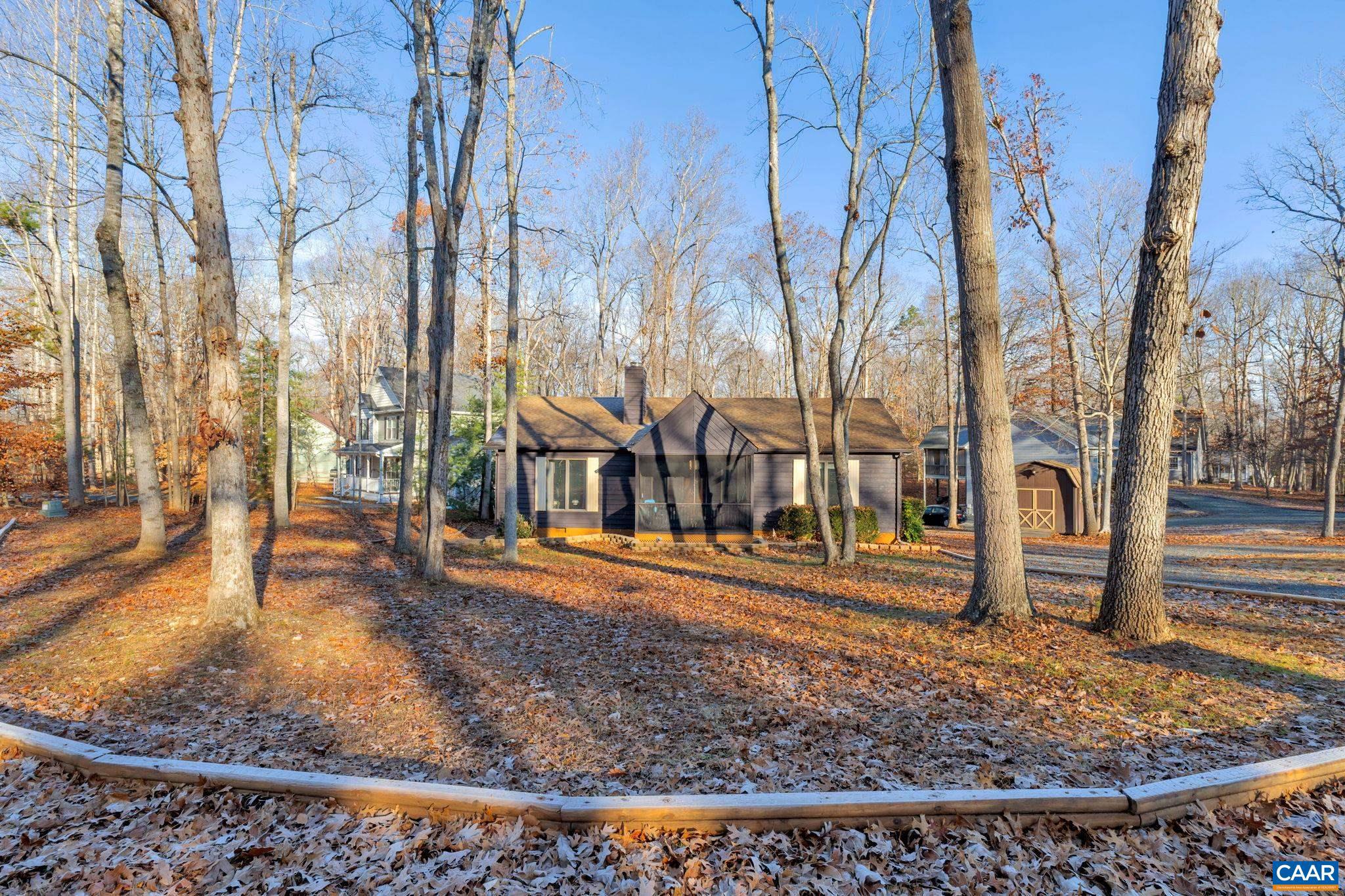 THIS VAULTED RANCHER IS A STUNNING HOME with a split bedroom design, offering privacy and comfort. The entrance features a screened front porch, perfect for enjoying the outdoors & greeting neighbors as they walk by. The living room boasts vaulted ceilings & two skylights, filling the space with natural light. Hardwood floors and a gas fireplace add warmth and charm to the room. The kitchen is equipped with a breakfast bar and a vaulted dining area with walk-out French doors, creating a seamless flow between indoor and outdoor living. Laundry room is conveniently located off the kitchen, and a nice kitchen pantry provides storage space. The kitchen also features a porcelain sink and a copper backsplash. The home's primary bedroom is spacious and includes an updated bathroom and a walk-in closet. Additional Features: Updated Baths, Spacious Bedrooms, Andersen Windows, Encapsulated Crawlspace, Backyard Storage Shed w/Electric, Circular Drive, & Nice Corner Homesite.,Formica Counter,Wood Cabinets,Fireplace in Living Room