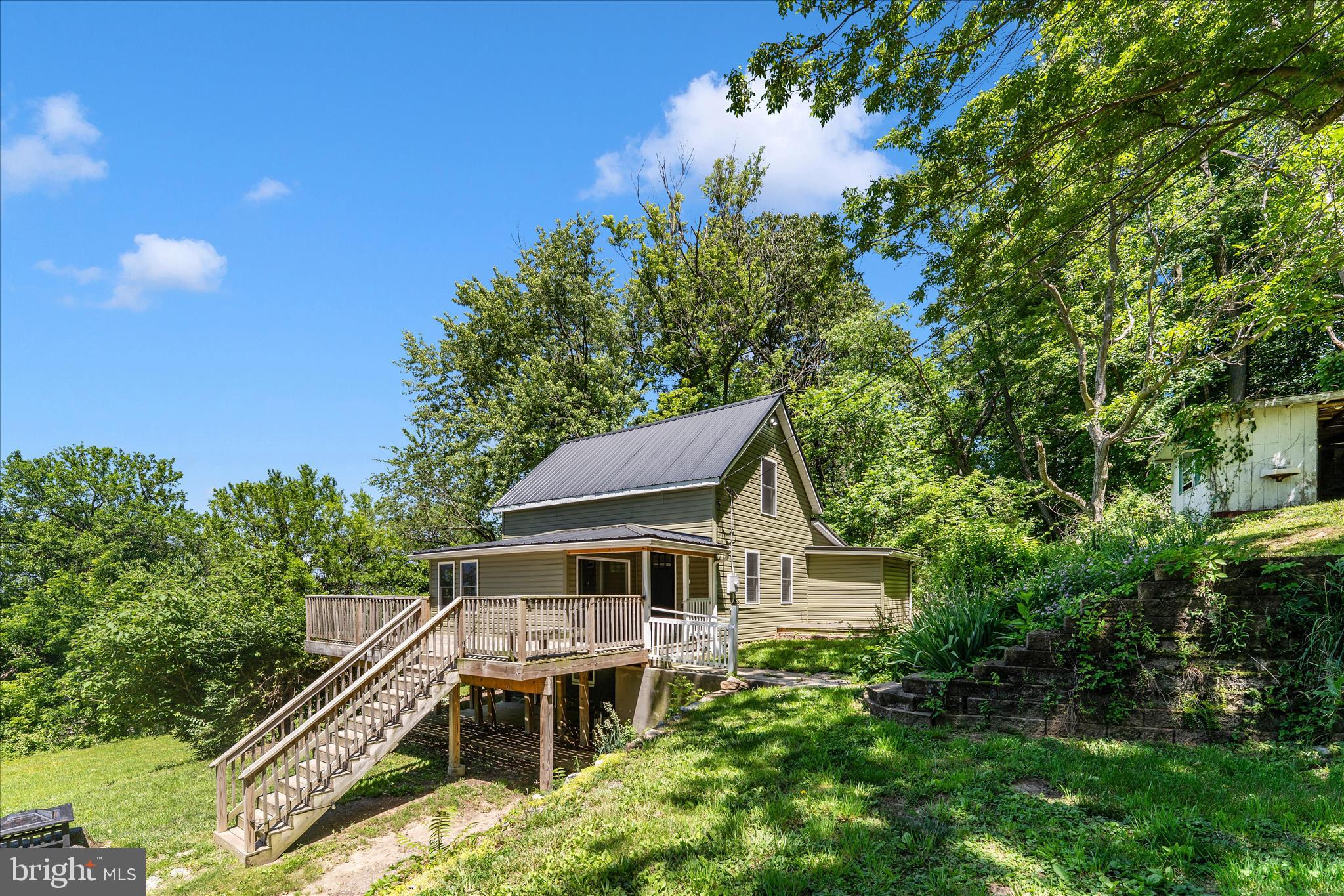 Beautifully renovated and move-in ready, this charming 2-bedroom, 1-bath cabin-style home sits on 1.24 scenic acres in the peaceful countryside of Smithsburg. Blending modern updates with timeless character, the property offers a unique opportunity to enjoy country living with beautiful mountain views and a thoughtfully updated interior. The renovated kitchen features new appliances and custom countertops, while spray foam insulation helps maximize energy efficiency and year-round comfort. The main-level primary bedroom includes a walk-in closet and convenient laundry area, and the upper level offers a spacious loft-style bedroom along with additional flexible living space. Thoughtful details throughout preserve some of the home's original charm while complementing the tasteful renovations, making this turnkey property a rare find for those seeking privacy, character, and picturesque surroundings.
