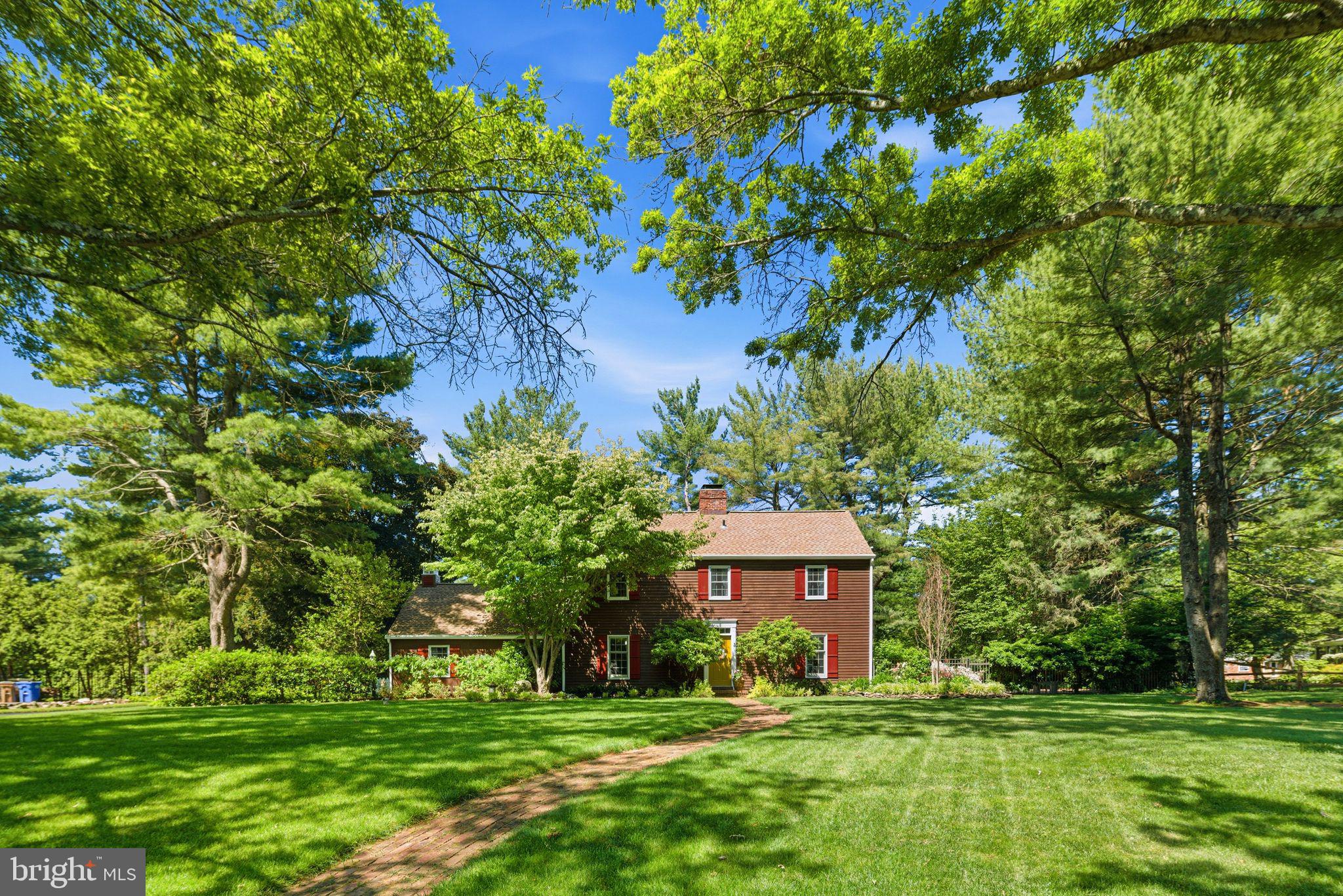 Meticulously maintained and beautifully renovated throughout, this stunning Saltbox-style Colonial is set on a large, professionally landscaped lot in the desirable Buckland Valley East Grant community built by premier custom homebuilder Ferman Lex. Positioned across from a picturesque treed open space, the home offers exceptional privacy, timeless curb appeal, and a rear-entry two-car garage. The backyard is truly an outdoor oasis, featuring a gorgeous fenced-in, propane-heated in-ground cement pool with an integrated spa and depths ranging from 3 to 9 feet. Extensive landscaping and multiple outdoor living areas create the perfect setting for relaxation and entertaining. Inside, a welcoming center hall foyer is flanked by a spacious living room and formal dining room. A beautiful wood staircase, accented by an exposed brick wall extending to the second floor, creates a striking architectural focal point. The sun-filled living room features walls of windows and French doors leading to a large screened porch, which is also accessible from the den. The formal dining room offers generous space for entertaining and connects conveniently to the kitchen. The cozy den showcases a brick fireplace and direct access to the screened porch, creating a warm and inviting gathering space. The renovated kitchen is both stylish and functional, featuring granite countertops, an elegant backsplash, abundant custom cabinetry, stainless steel appliances, a built-in electric cooktop, double ovens, and a premium refrigerator. A breakfast area and serving bar open seamlessly to the den. Adjacent to the kitchen are a side entrance, laundry room with garage access, and entry to the basement. The partially finished basement provides additional living space, including a bar area and a versatile workshop or hobby space. Upstairs, the spacious primary suite offers abundant closet space and a beautifully renovated ensuite bath. Three additional bedrooms and an updated hall bathroom complete the second floor. A turned staircase overlooks the home's dramatic brick chimney wall, adding character and architectural charm. Throughout the home, you'll find hardwood flooring, crown molding, wainscoting, and warm neutral paint tones that enhance its timeless elegance. A matching storage shed is also included and will be conveyed in its present condition. Set on a premium, private lot with exceptional landscaping, this remarkable property offers a rare opportunity to enjoy tranquility, luxury, and outdoor beauty in one of Upper Makefield's most desirable locations. Showings will begin Sunday, 6/7, at Openhouse 12 Noon - 2 PM.