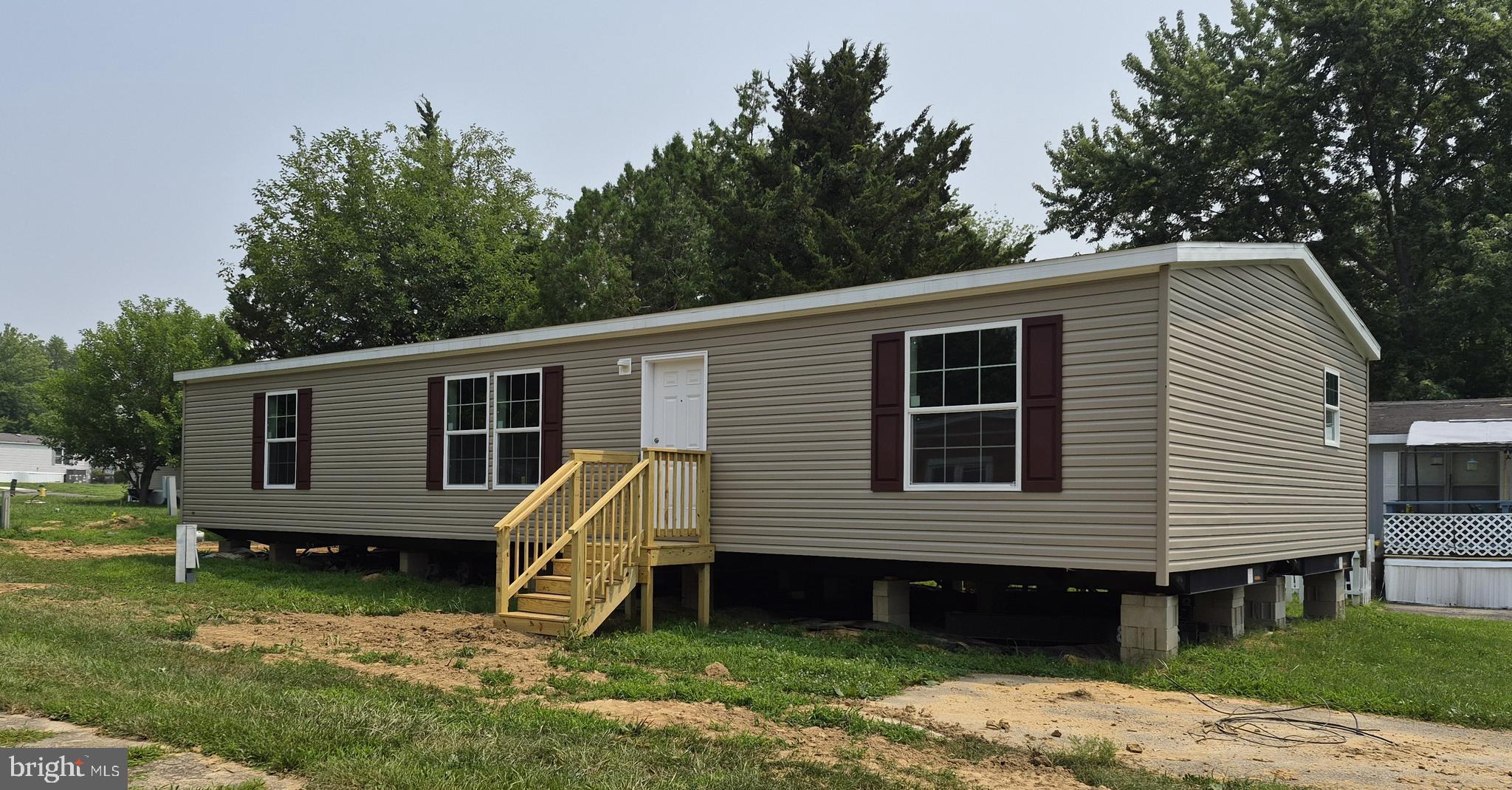 2026 Skyline "Apex 3900" manufactured home. Beautiful 3/2 double wide home with modern updates. Split floorplan with open layout, recessed lighting, vinyl flooring all throughout, walk-in closets in all bedrooms, ample storage, and 8 feet tall flat ceilings.. Stainless steel appliances in the kitchen, full size washer & dryer, large pantry with plenty of storage.  Built to HUD standards with 2 x 6 exterior walls, thermal windows & shingle roof.  10-year warranty included!  Lot rent of $933 monthly includes, snow removal, common ground maintenance, trash removal, utility infrastructure, nature & green spaces.
