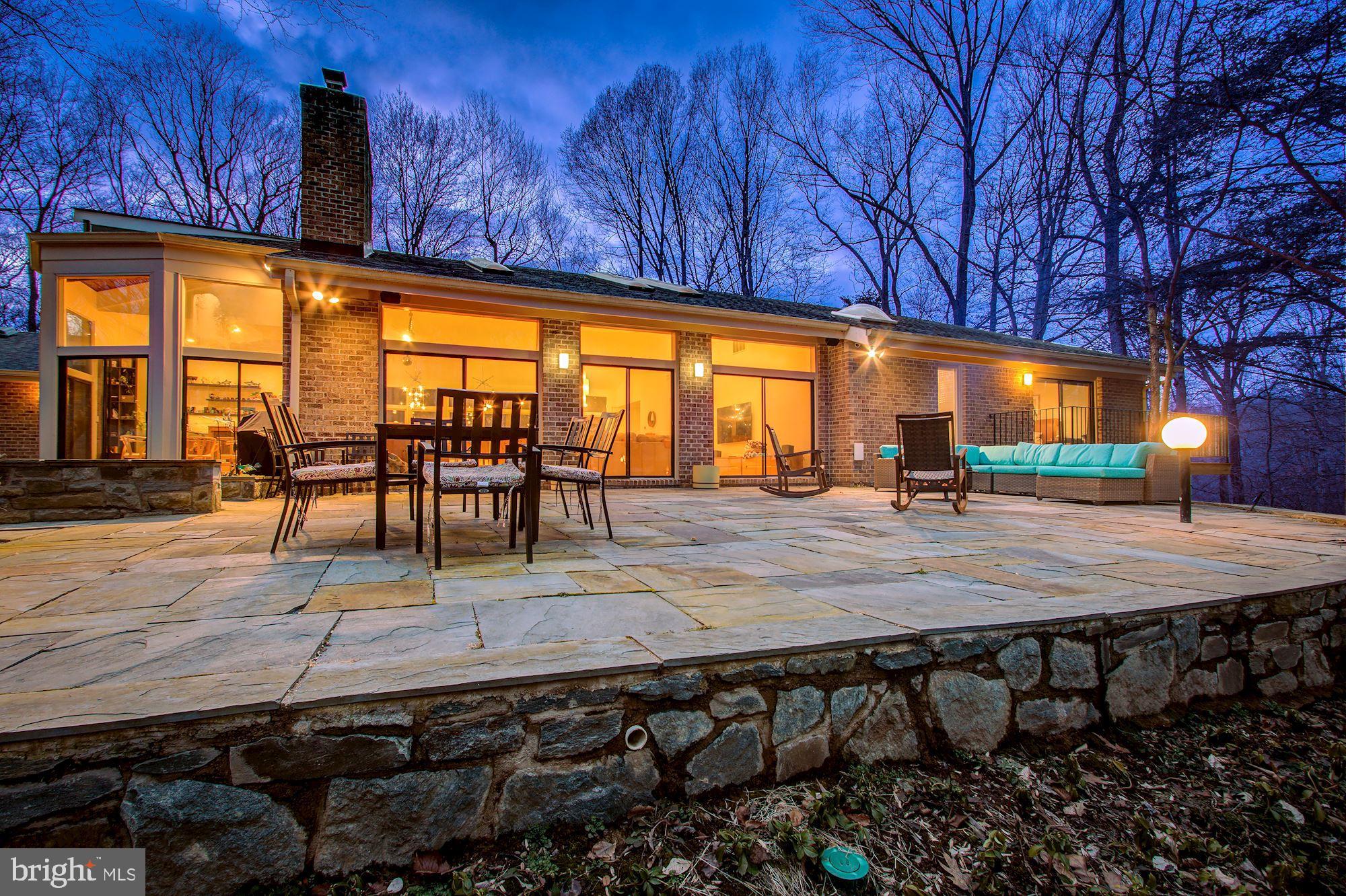OFFERS DUE WED 3/31 5pm - Upgraded Mid Century Modern-inspired home offers a daily escape from the ordinary, in privacy on 2 acres. Enter the 6 bedroom 4 bath 2 half bath two-level home into a soaring open vaulted space which peaks at nearly 19 feet high. Morning sunlight drenches the rear of the home through skylights, floor to ceiling windows, and a unique wood-detailed ceiling in the breakfast room, all designed to bring views of nature inside. A wood and metal-detailed fireplace façade anchors the grand entertaining space. Exquisite Poggenpohl kitchen crafted with German-made materials of the highest quality, engineering and environmental standards . Expanded sleek island with a modern cooktop. The natural light-infused breakfast room will become your favorite sanctuary for meals, reading or day-dreaming. For mild weather entertaining, all the rear sliders open to a newly expanded slate patio.  Off the kitchen is the mud room/laundry which is the work-horse of the home, featuring abundant cabinetry, storage space, a second dishwasher, additional fridge/freezer and new powder room.  The left wing of the home houses 4 ample bedrooms, 3 and a half baths and private living spaces. The owners’ suite includes a new home office that opens with a barn door into the living space. It features a newly designed ensuite full bath delivering contemporary dual sinks and a “wet room” shower/bath. The owners’ bedroom has a private deck overlooking the private wooded lot.   Three additional bedrooms, including one with retro walnut flooring and a new ensuite full bath. The lower walk-out level adds ideal space for multi-generational independent living arrangements, or even AirBnB revenue, which topped $21,000 for 88 nights in 2020. Separate entrance and side driveway. Two spacious bedrooms with egress, a new full bath, a second laundry room with fridge, spacious family room with cork flooring, a dining area, wet bar and other accommodations. A working sauna, fitness room, craft or other use room. A home theater pre-wired for 7.1 sound, and a 83” Samsung smart TV (conveys) complete the space in this stunning home for modern living! Book now for showings starting  March 27.