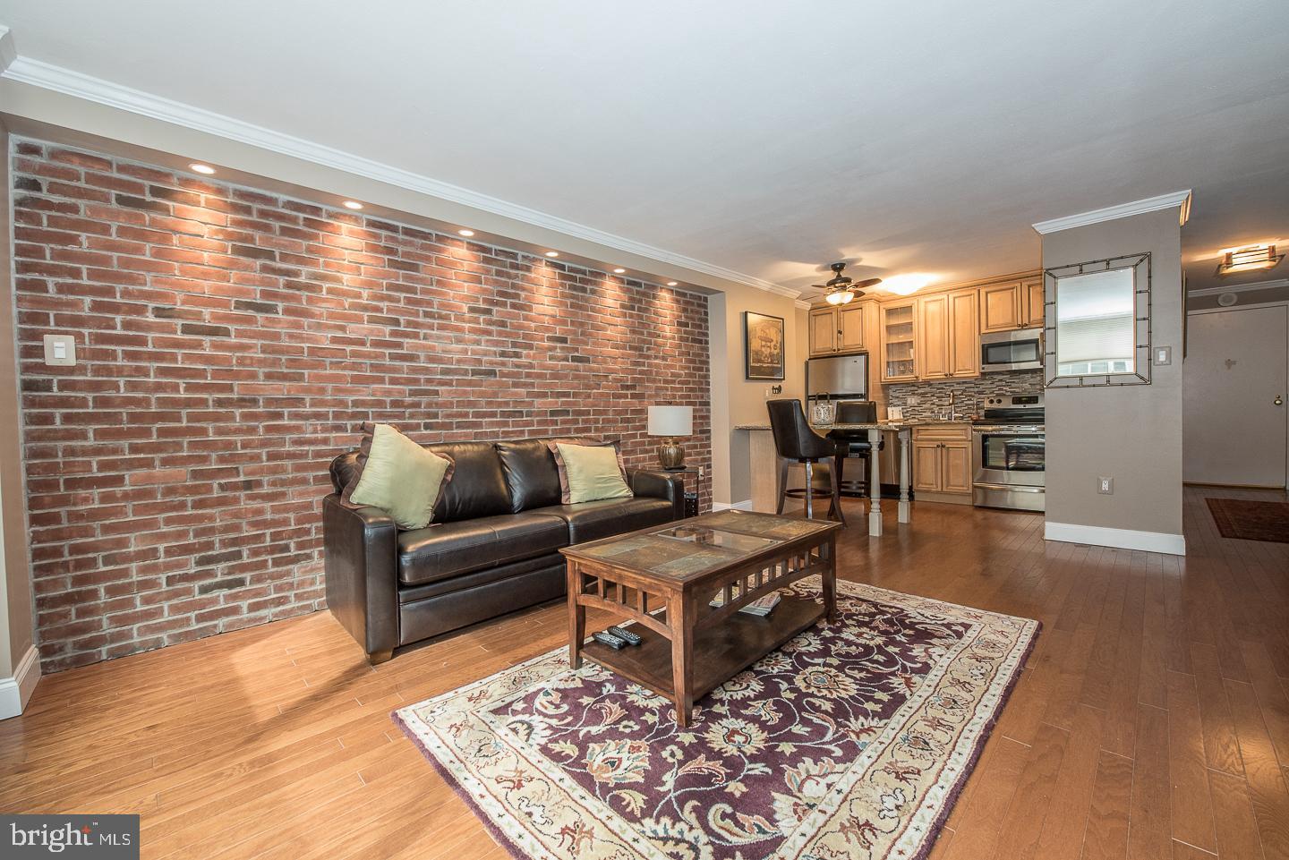Enjoy effortless city living in this beautifully updated 475 sq. ft. efficiency at the desirable Kennedy House in the heart of Rittenhouse Square. The spacious, open-concept living area features recessed lighting, a striking exposed brick accent wall, elegant crown molding, and a cozy electric fireplace with a beautiful stone surround that creates a warm and inviting focal point. The open eat-in kitchen is equipped with a breakfast bar, granite countertops, stainless steel appliances, and ample cabinet space, making it perfect for everyday living and entertaining. The updated bathroom offers a full bathtub and additional storage, while generous closet space, a complimentary storage locker, and newer top-of-the-line windows complete this move-in-ready home. The Kennedy House offers exceptional amenities including 24-hour security and doorman service, on-site management and maintenance, a spectacular rooftop swimming pool and sun deck with breathtaking city views (currently undergoing an extensive renovation), a complete fitness center for just $120 annually, hospitality suites, a 30th-floor community laundry facility, and on-site garage parking available at approximately 50% below standard Center City rates. The monthly co-op fee includes nearly everything: all utilities (electric, heat, air conditioning, water, and basic cable), real estate taxes, and the building's maintenance package, providing outstanding value and simplified living. A nominal real estate transfer tax applies, and title insurance is not required. Ideally located just one block from Suburban Station, three blocks from 30th Street Station, and within easy access to SEPTA transportation, The Kennedy House places you steps from some of Philadelphia's finest restaurants, shopping, theaters, museums, and cultural attractions. Kennedy Market and Chima Brazilian Steakhouse are conveniently located within the building. A one-time administrative fee is paid at closing. Experience the very best of Center City living in one of Rittenhouse Square's most established and sought-after cooperative communities.
